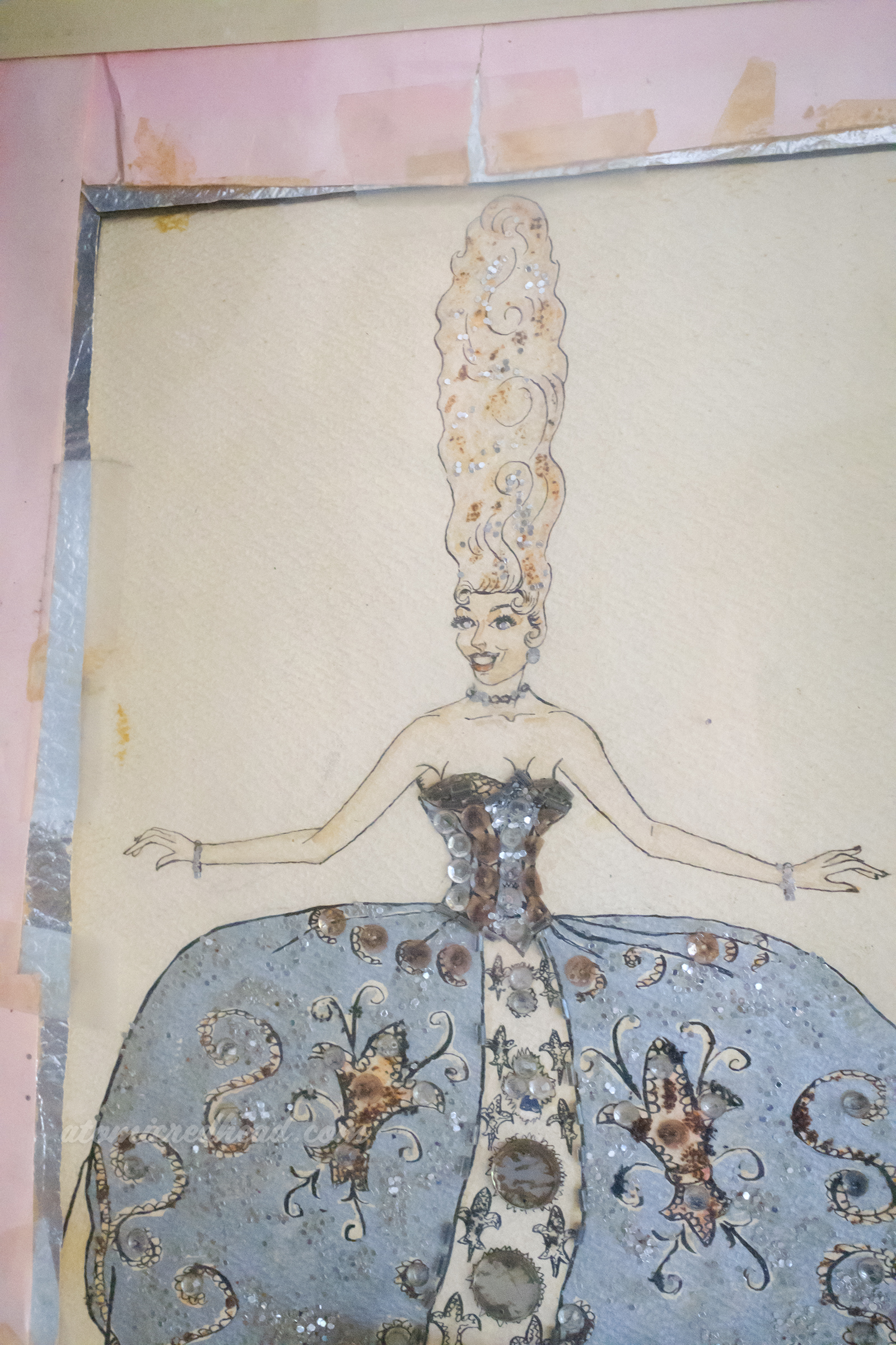 Illustration of a woman in a Marine Antoinette style of costume with a tall wig and wide dress.