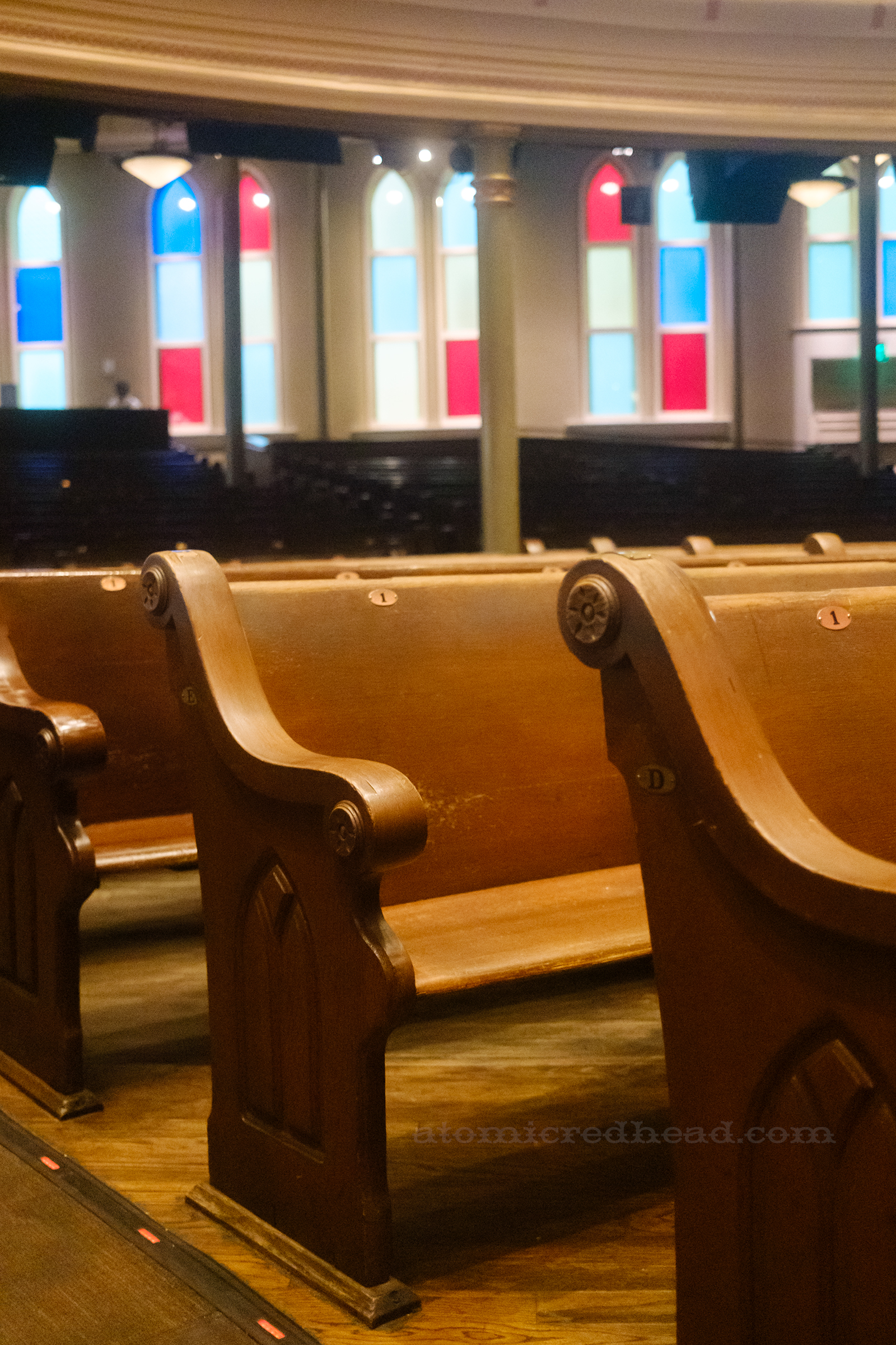 Close-up of the pews, which have arched windows carved into the edge.