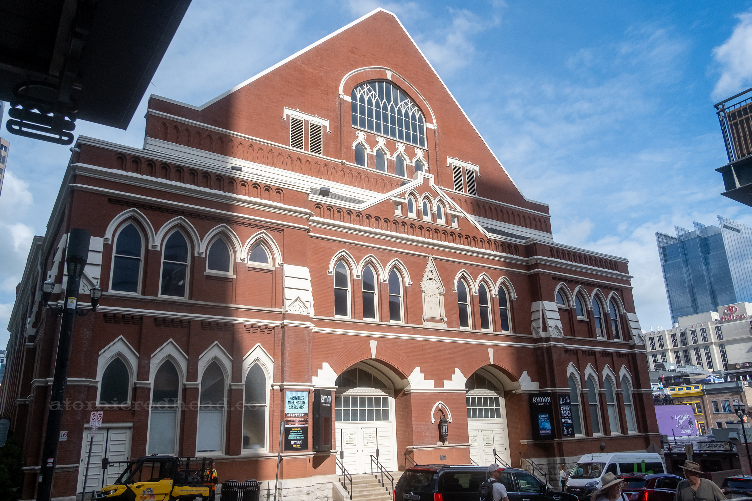 Exterior view of the Ryman, a multi story brick building with white details and a peaked roof.
