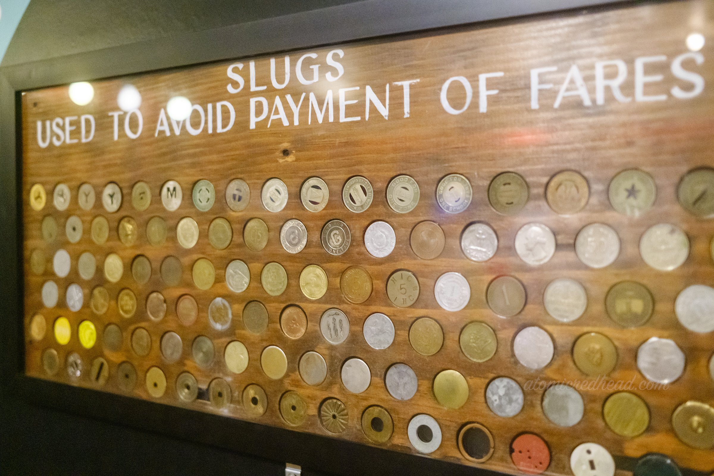 A framed collection of "slugs" that people used to avoid fair payment.