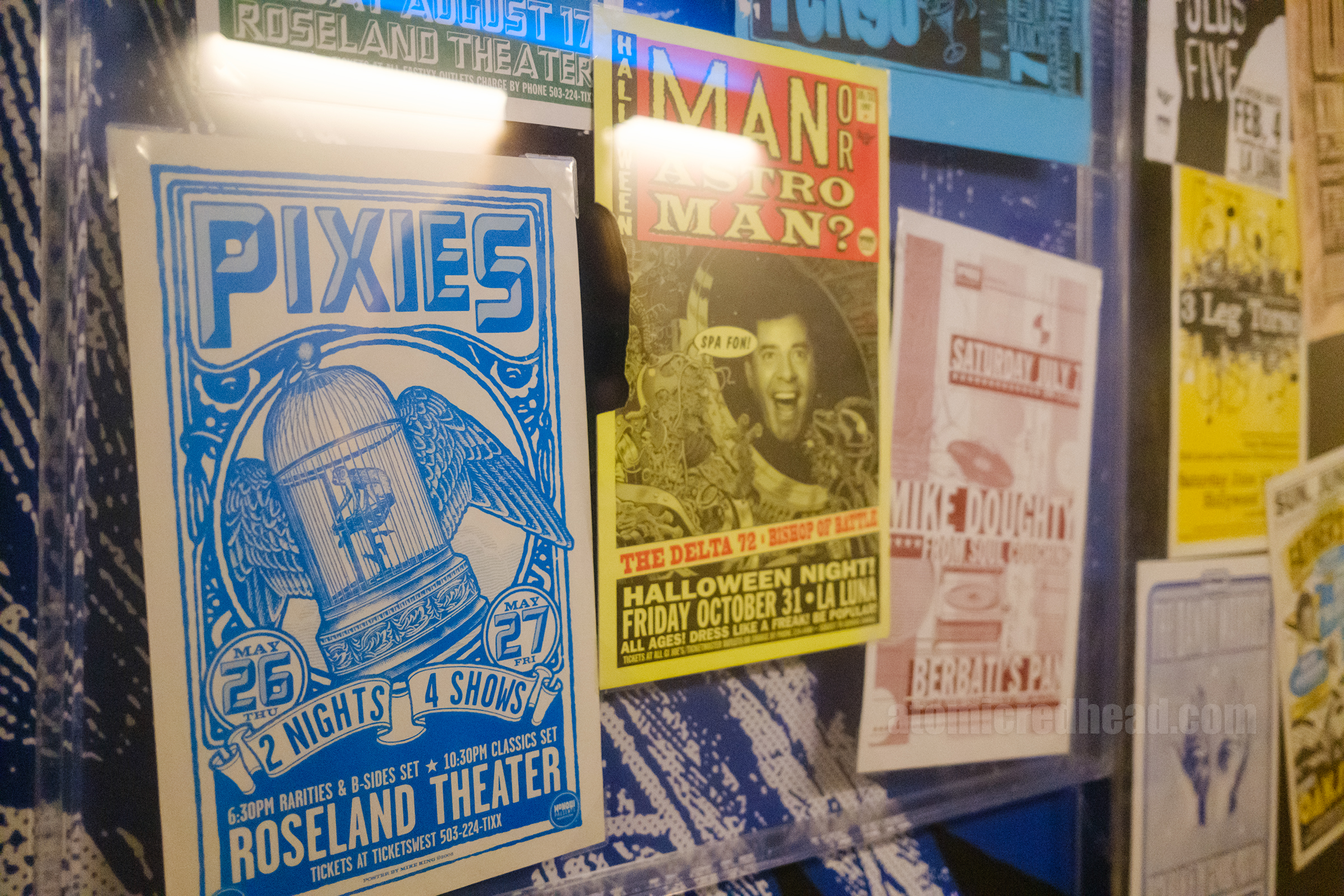 Colorful gig posters including The Pixies.