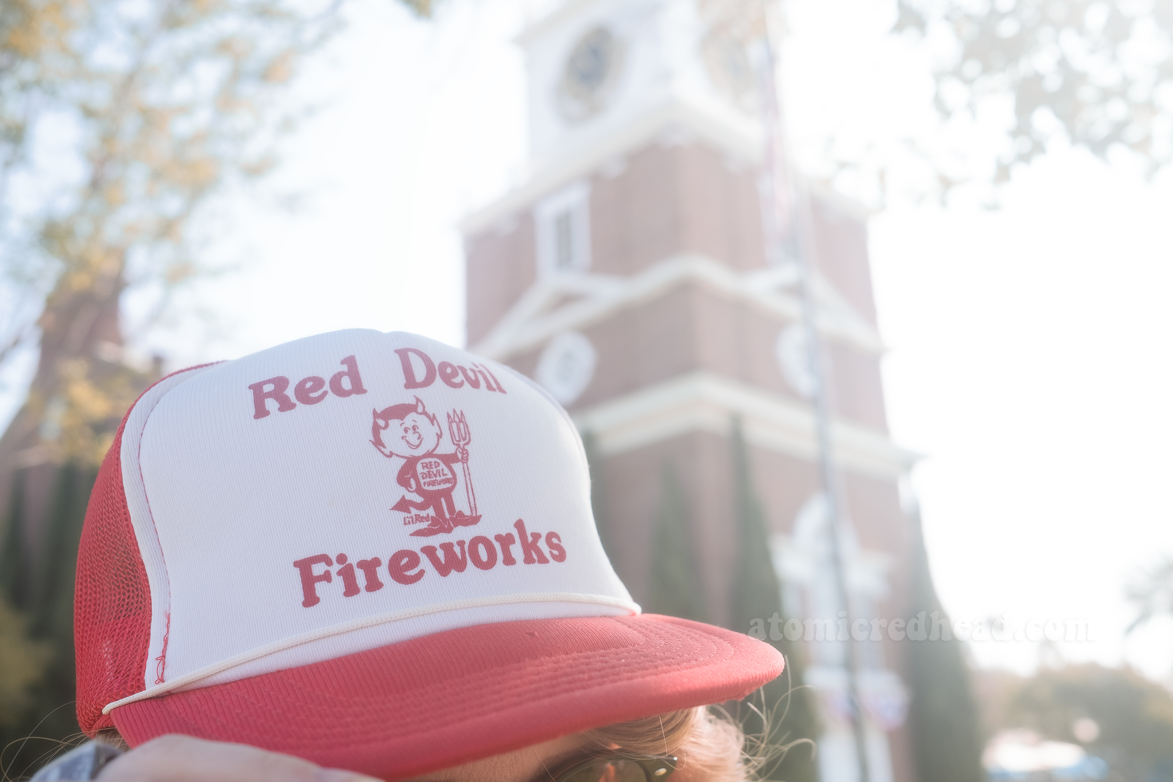 Close-up of my red and white hat that features a little devil figure and text reading "Red Devil Fireworks"