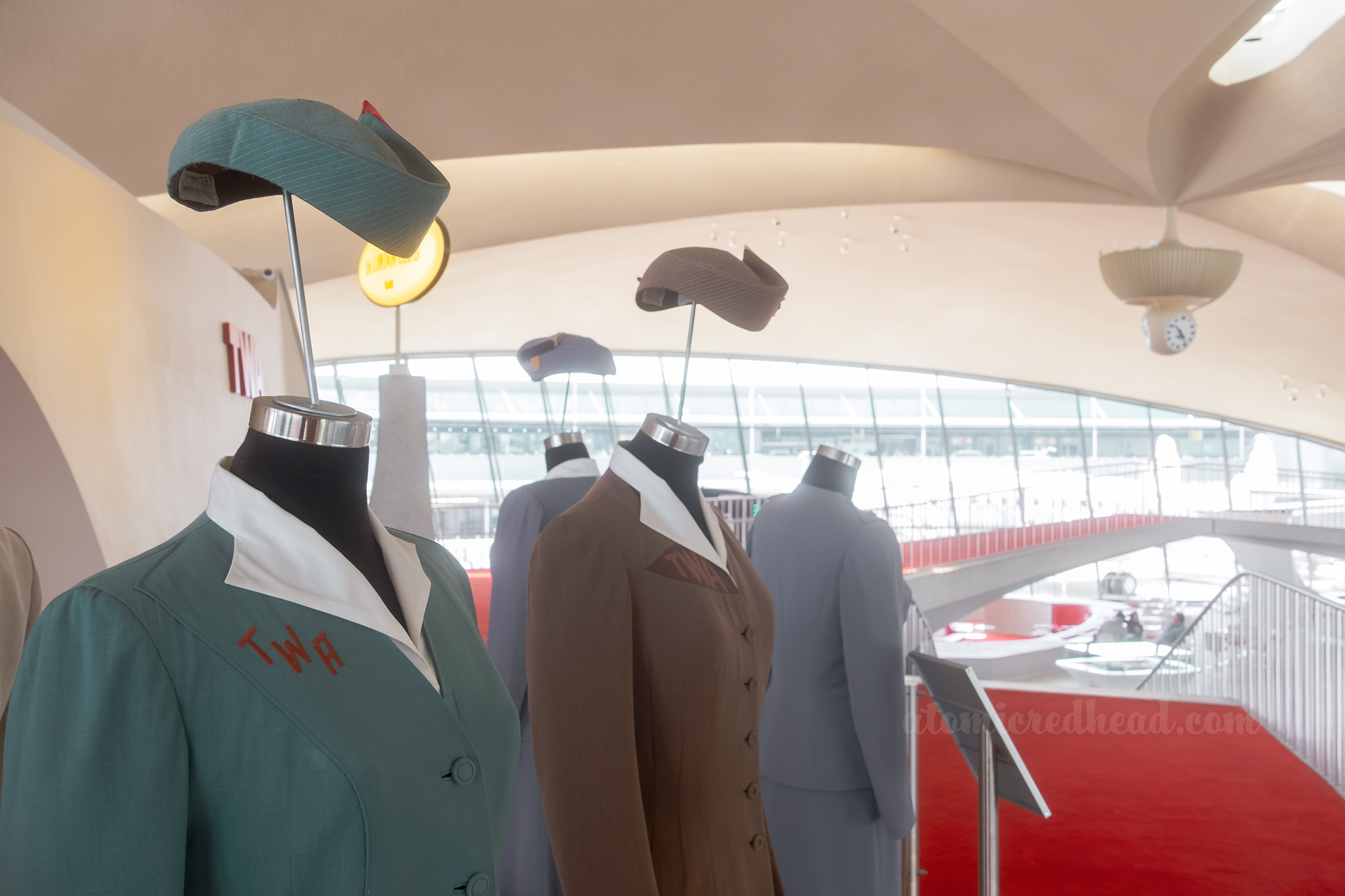 Close-up of three vintage TWA stewardess uniforms.