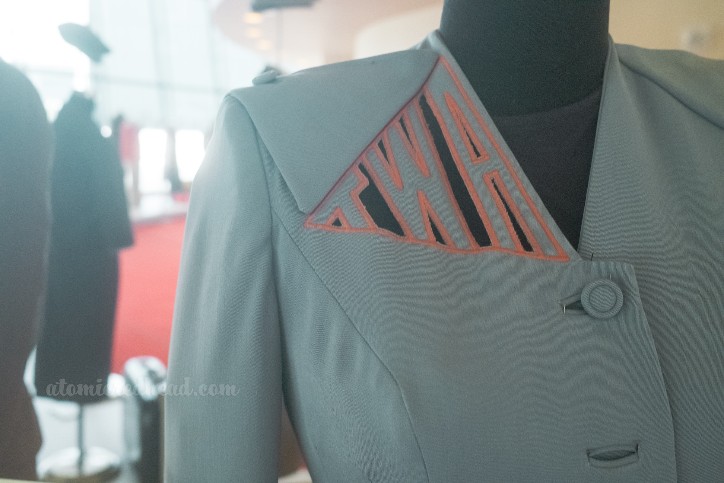 Close-up of "TWA" that is cut out on the shoulder of a stewardess uniform.