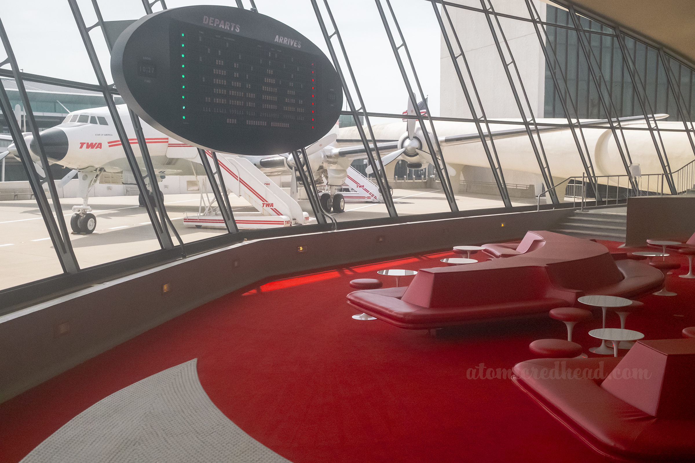 Close-up of the old arrival and departure board that hangs in the middle of the window of the sunken lounge.