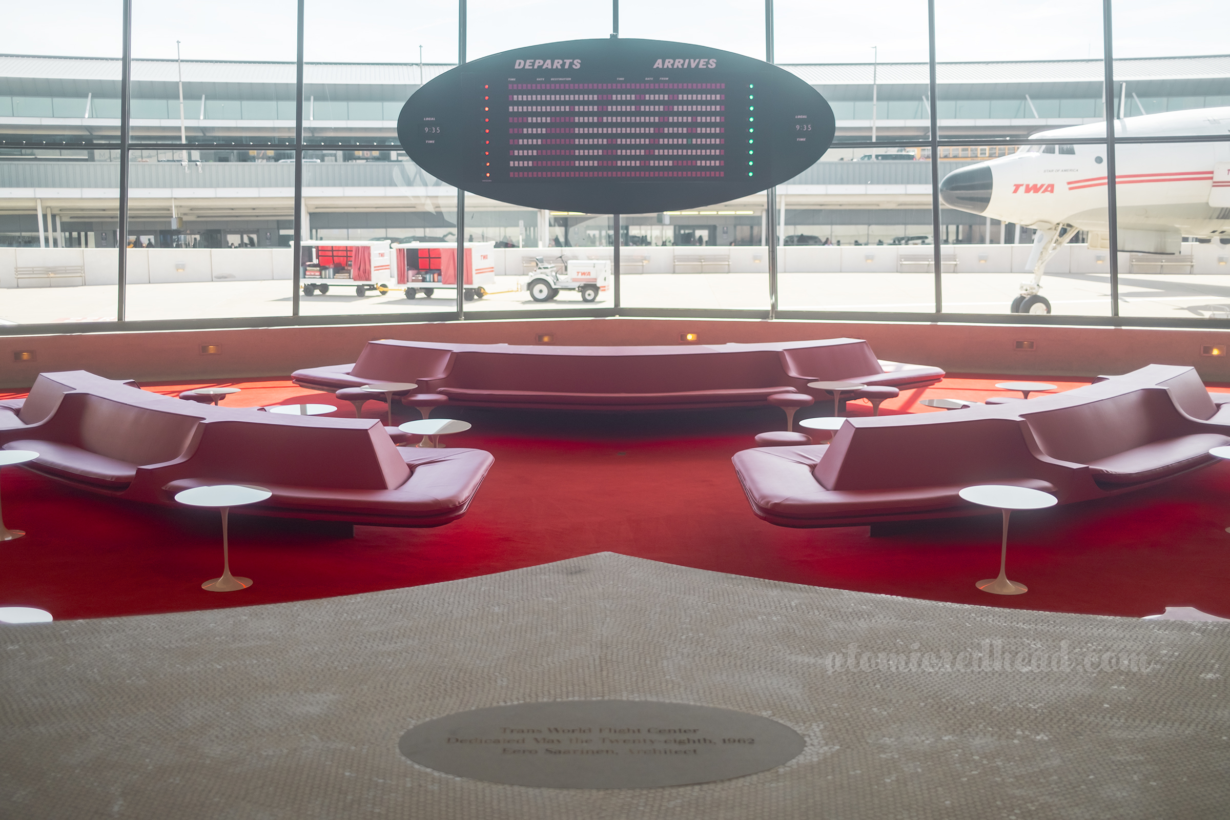 The old arrival and departure board rotates through text and images, seen here with the TWA logo.