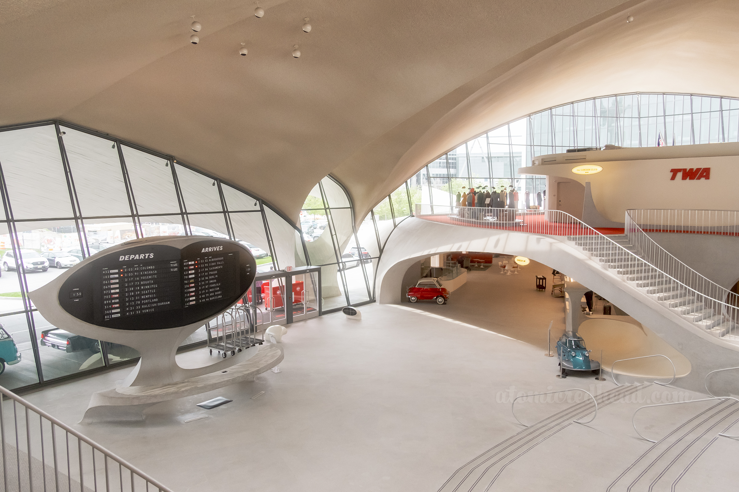 Overall of the front lobby, with staircases on the right and the arrival and departure sign on the left.