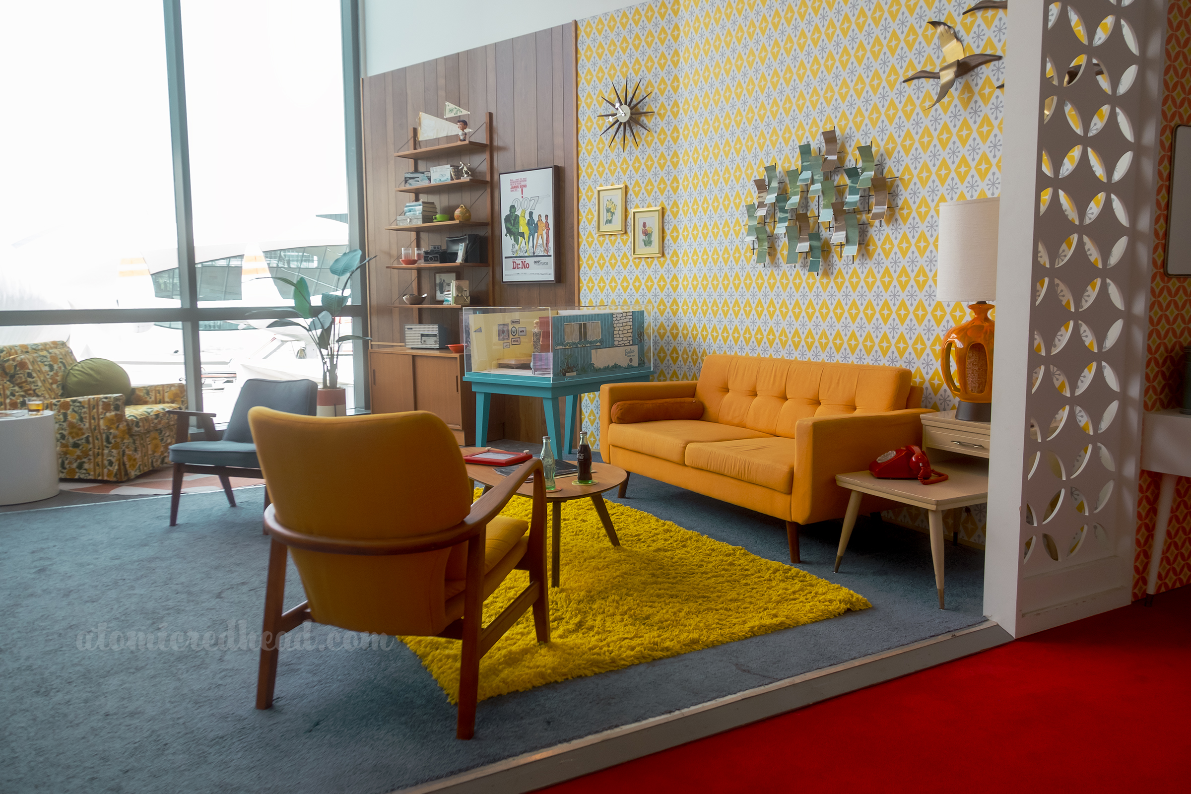 A faux 1960s living room with bright mid-century furniture.