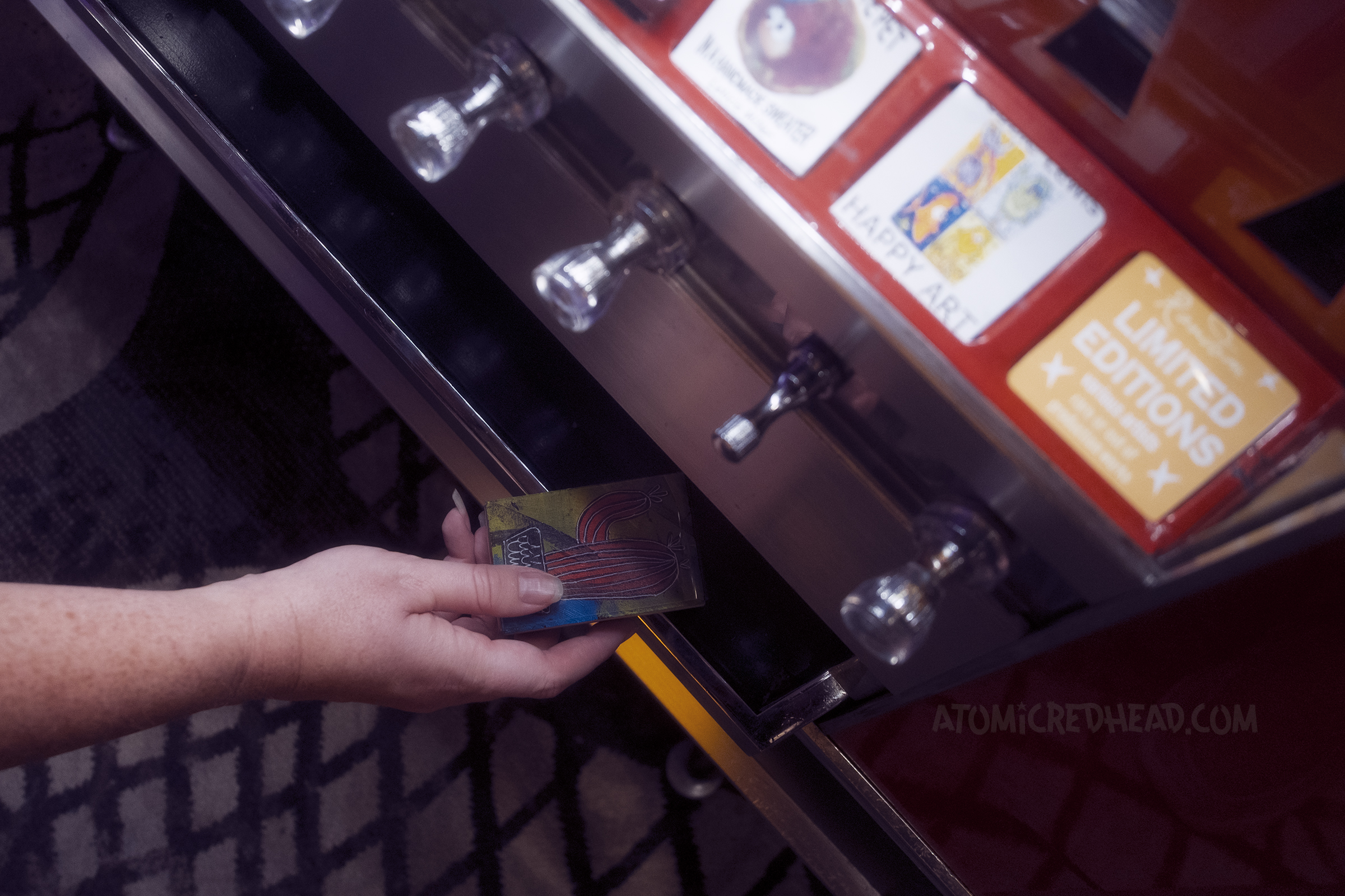 My hand comes in from the left, pulling out a small print of a cactus.