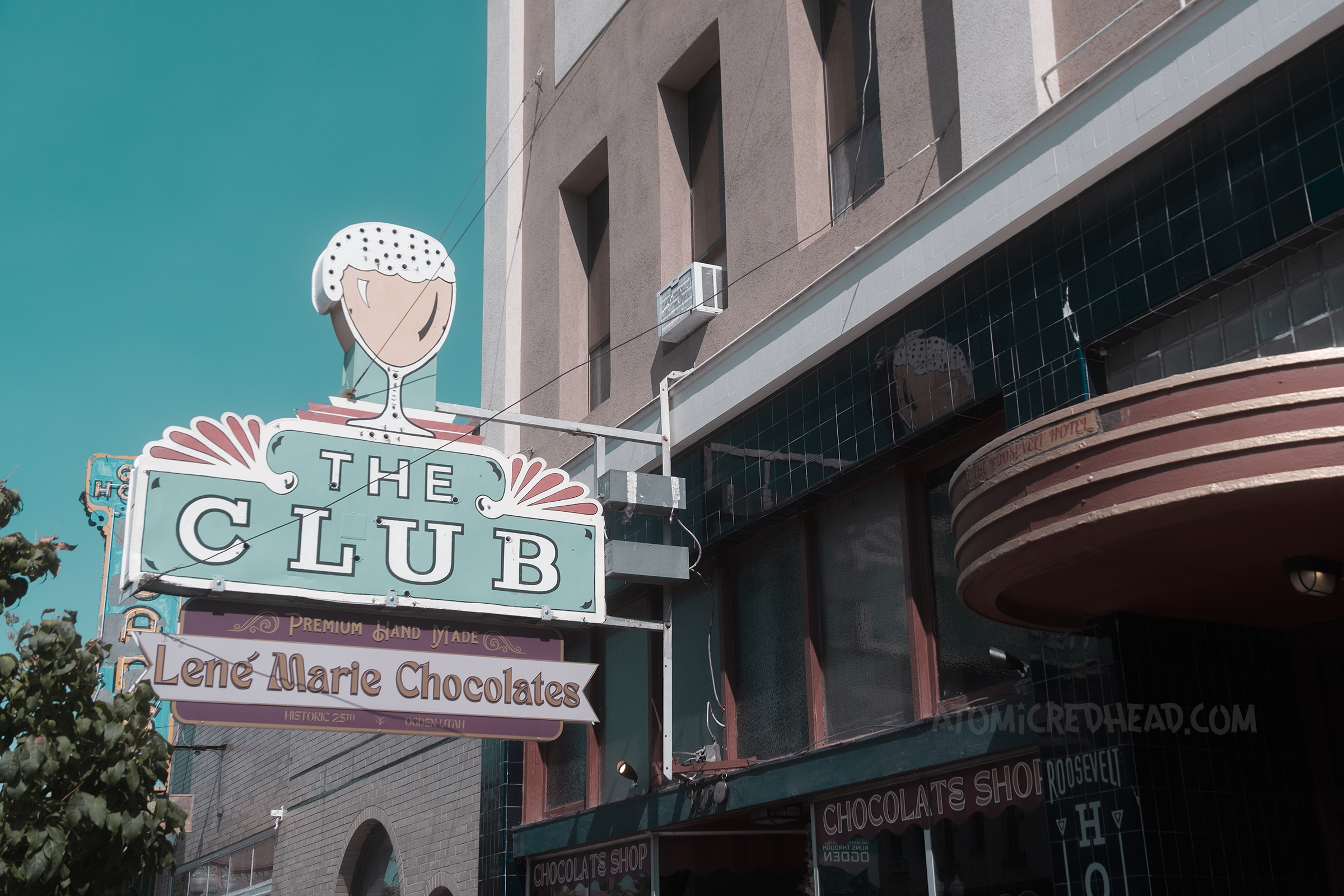 A sign with a large overflowing beer and text reading "The Club"