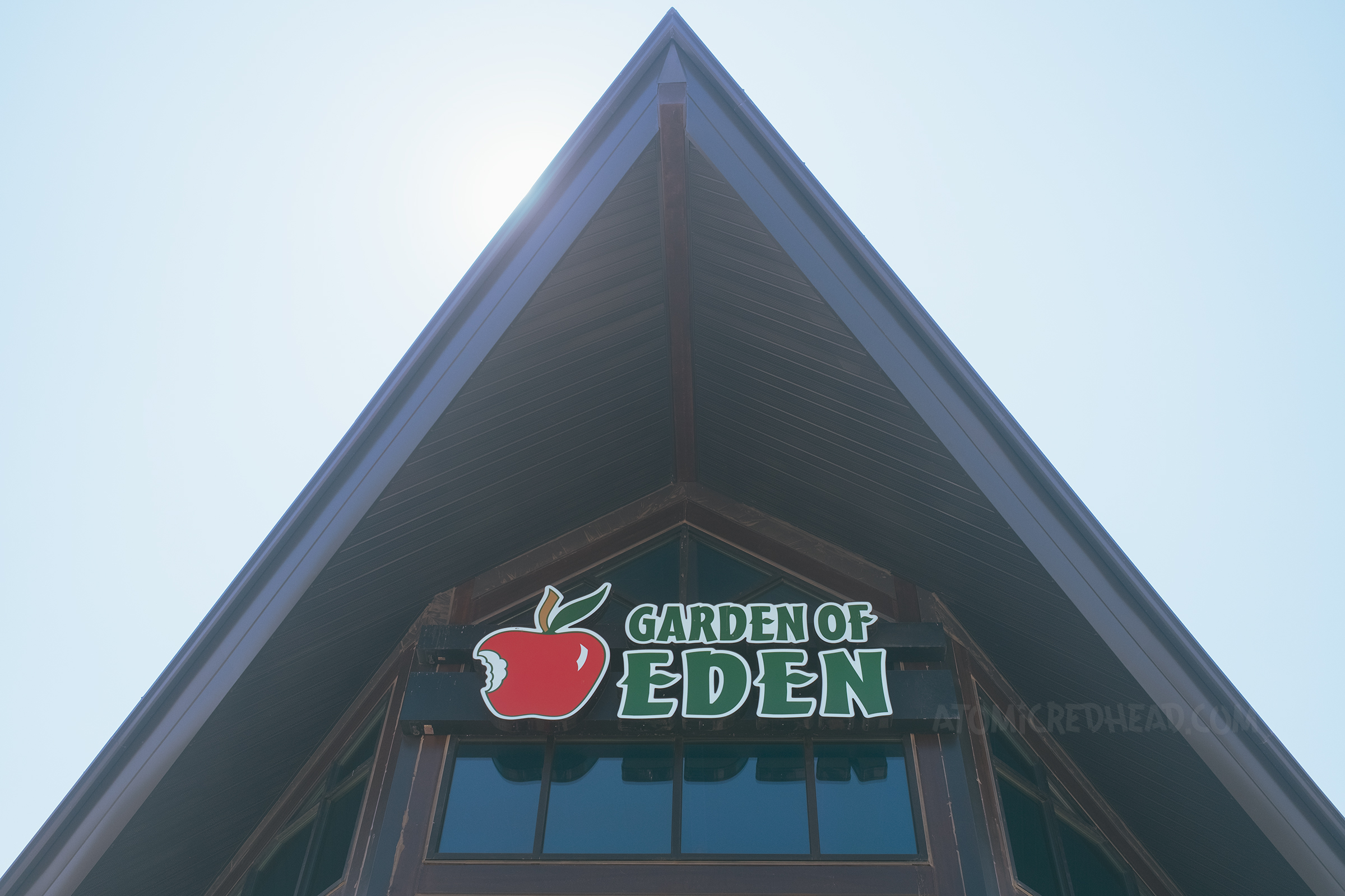 A large peaked roof with a plastic sign reading "Garden of Eden" with an apple with a bite out of it.