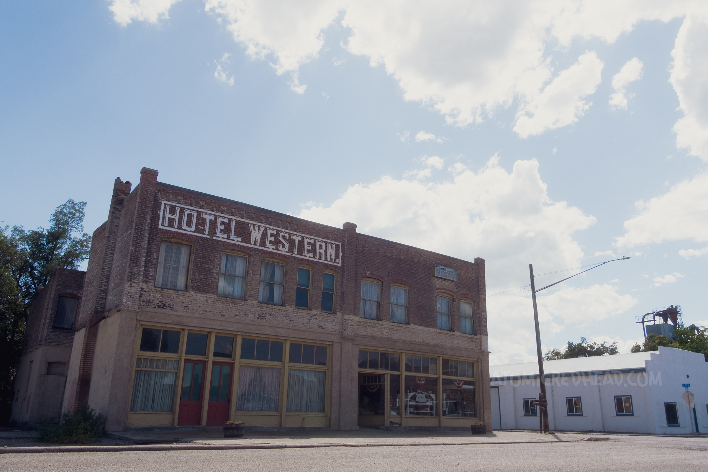A two story brick structure with white letters reading "Hotel Western"