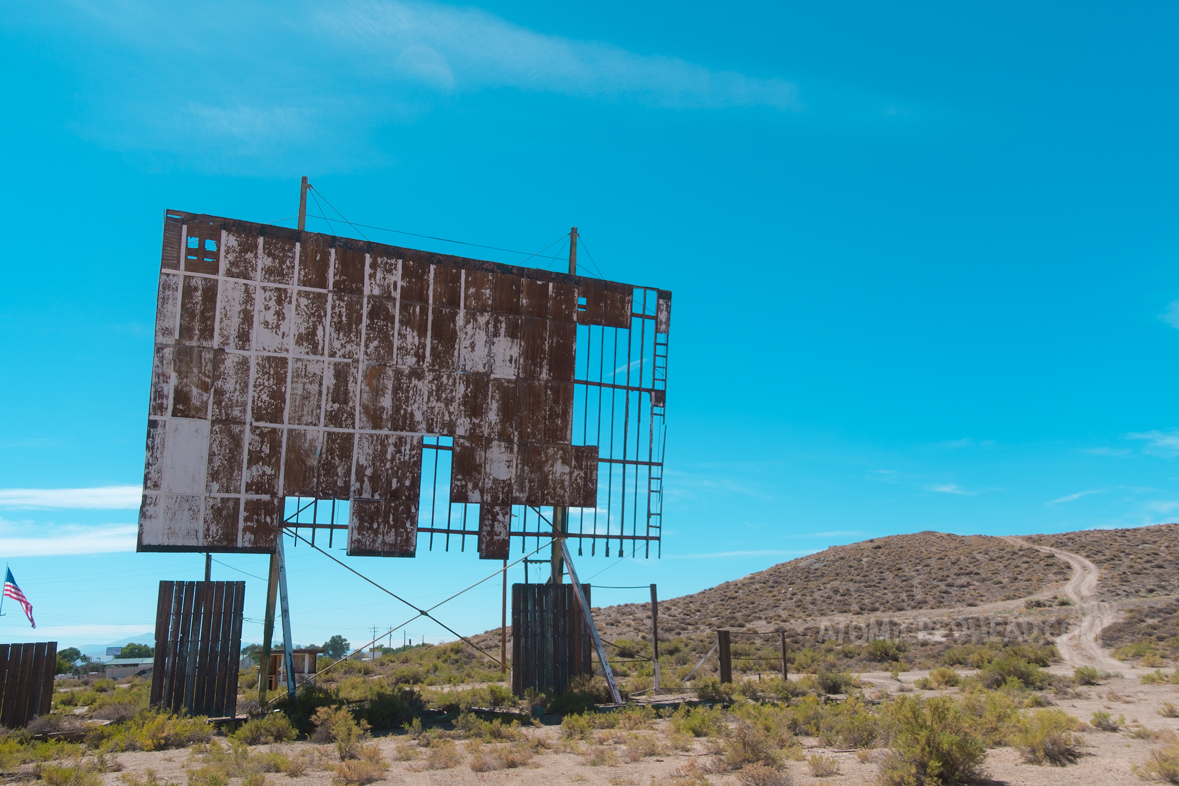 View of the screen, flaking white paint clings to the remaining panels.