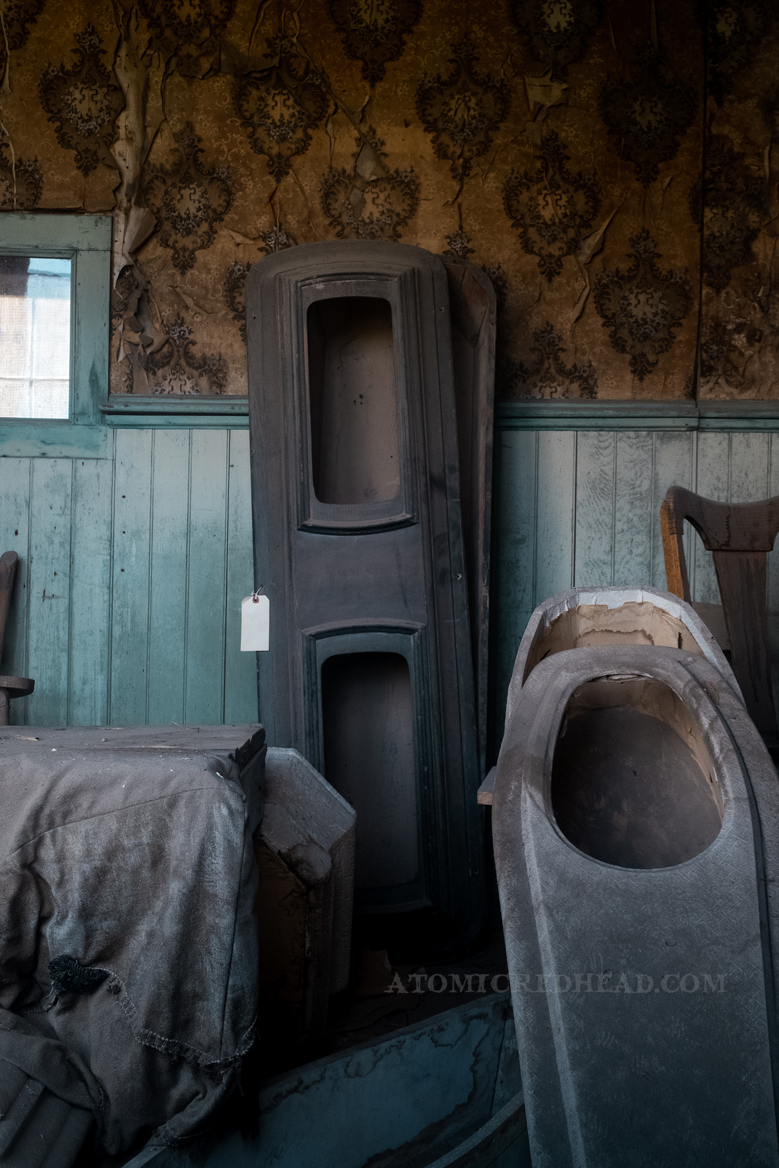 Inside the old morgue, with a variety of old coffins around.