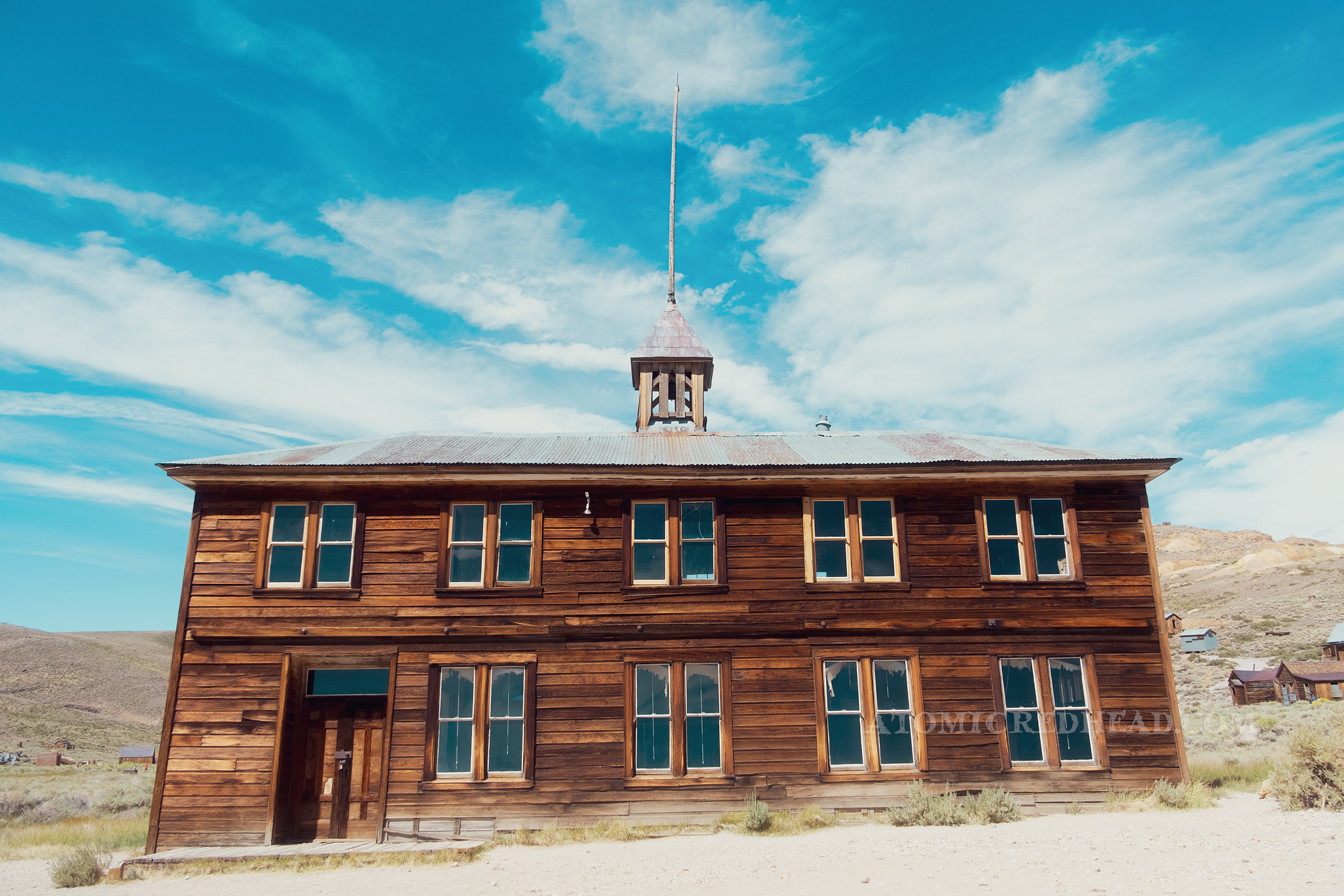 Exterior of the old schoolhouse, a large two story wooden structure. 