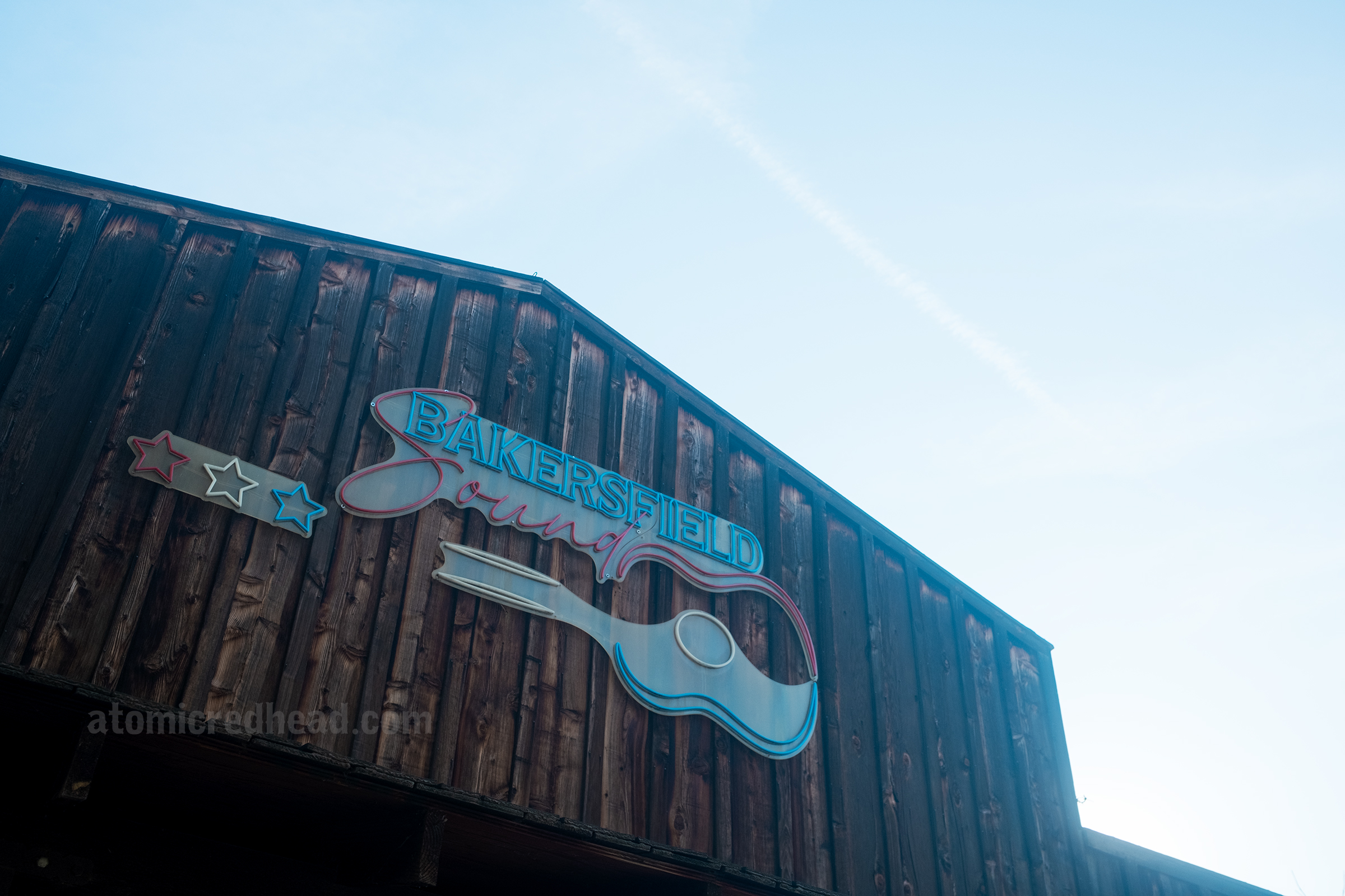 A wooden sided building with a sign that reads "Bakersfield Sound"