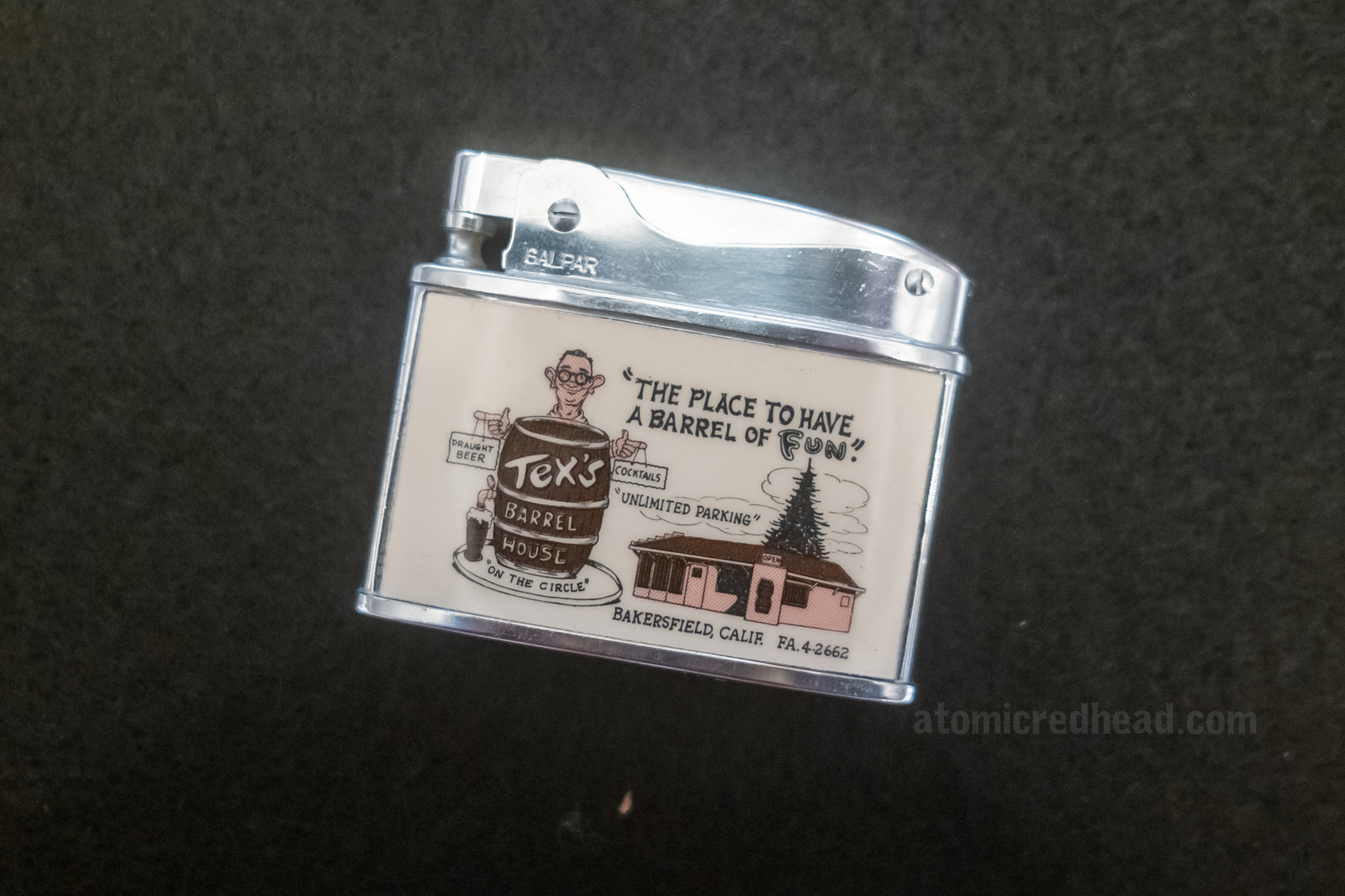 Vintage lighter with the Tex Barrel House on it.