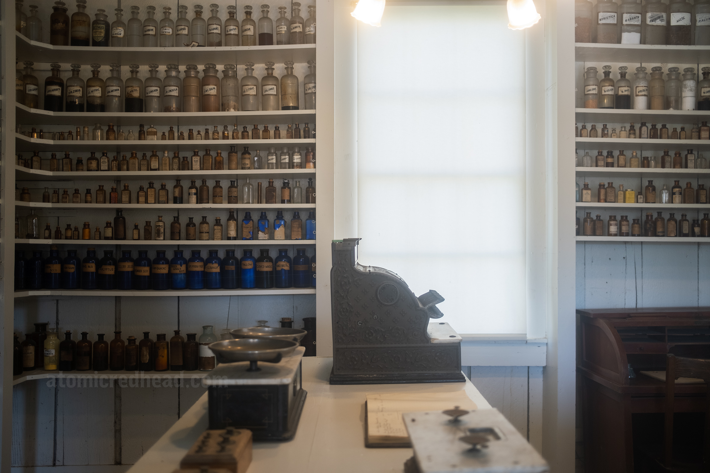 View inside the drug store with shelves of bottles.
