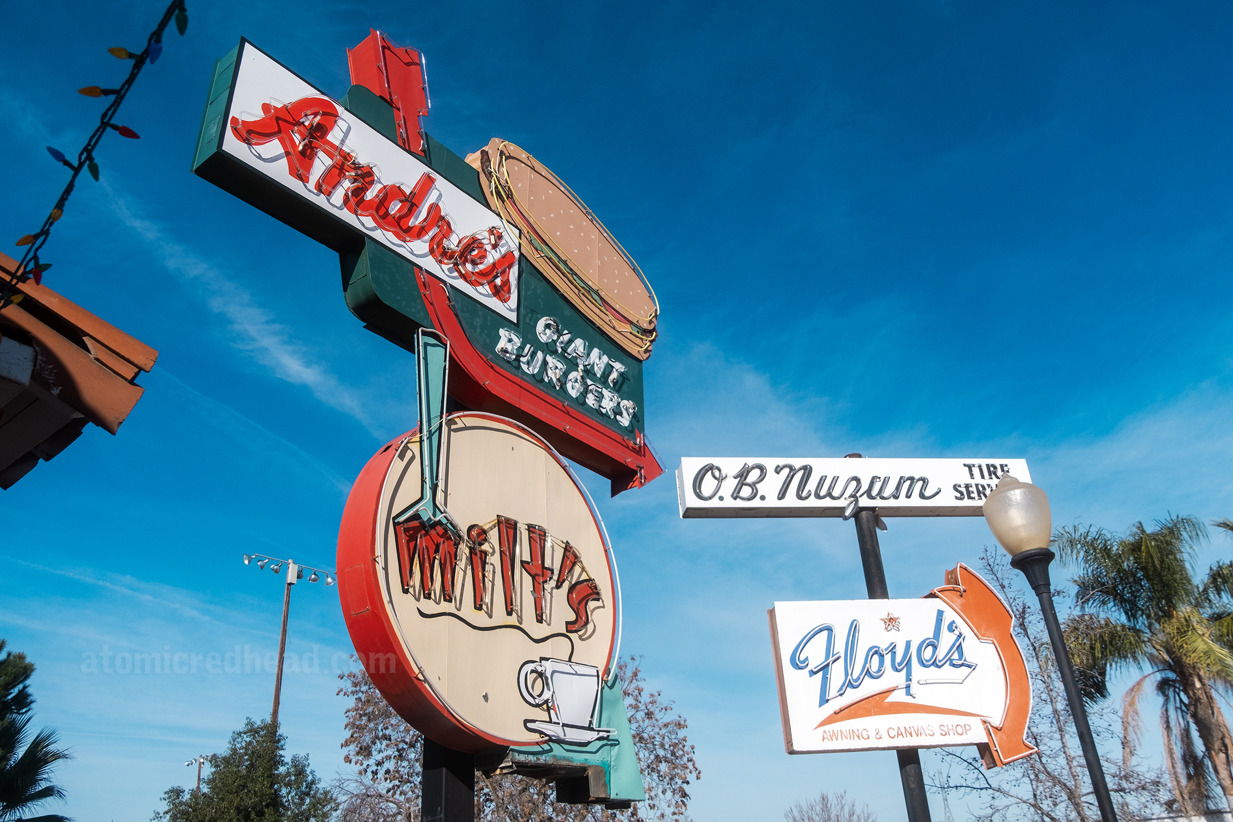 Neon signs for Andre's Giant Burgers and Milt's Cafe.
