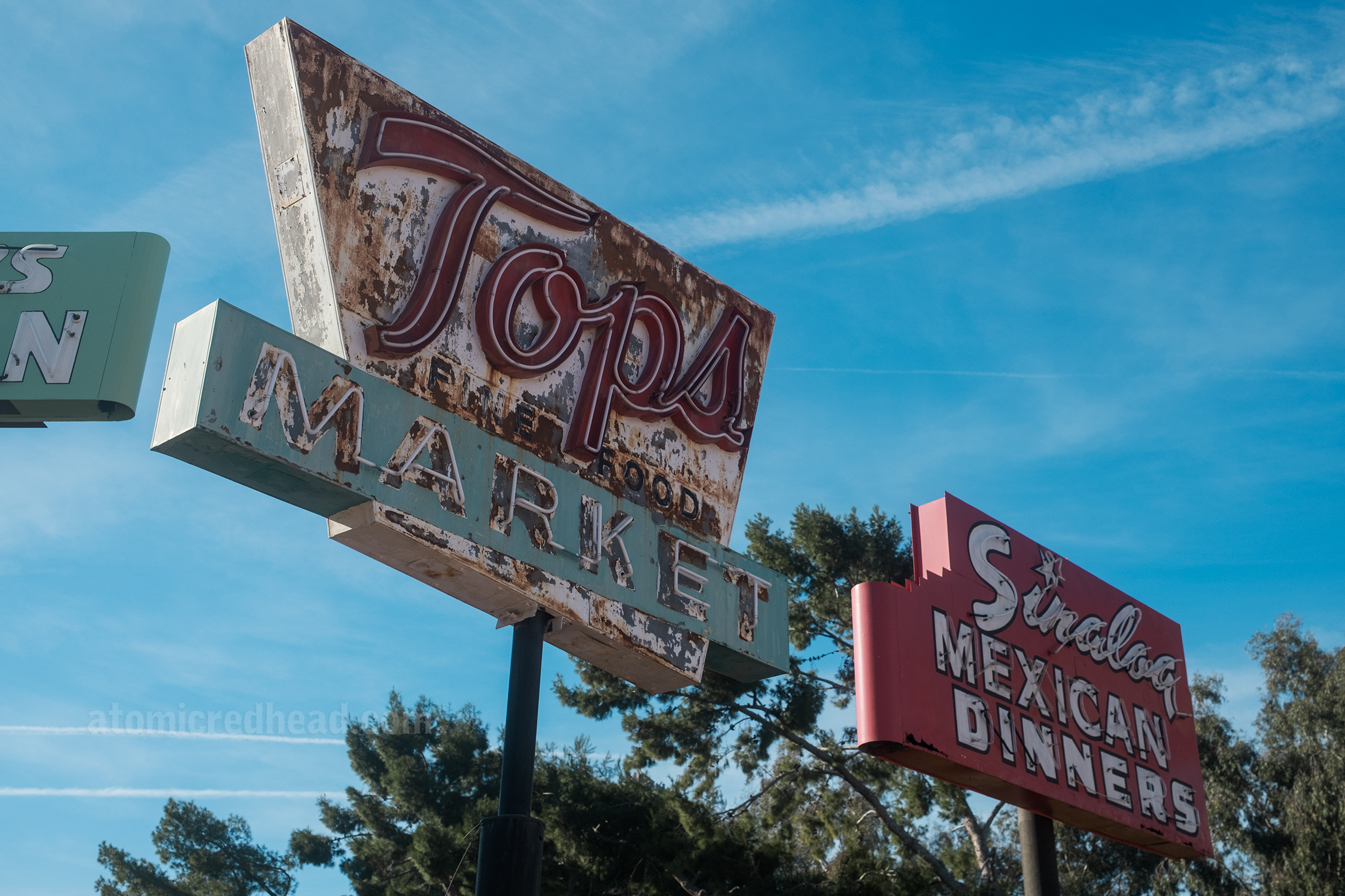 A neon sign for Tops Market.