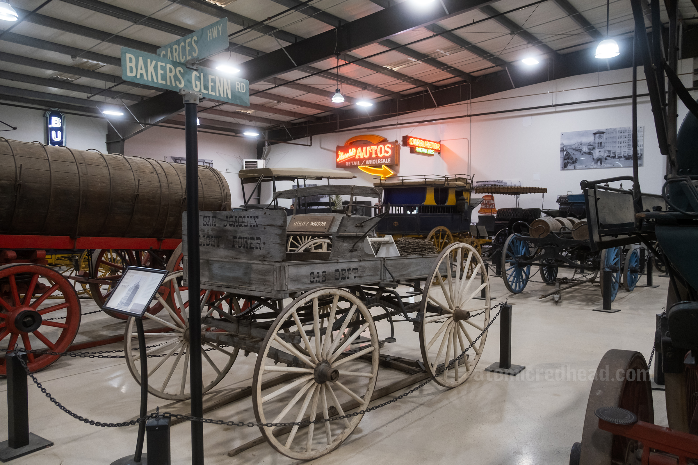 Overall of the carriage and car warehouse with various wagons, carriages and cars. 