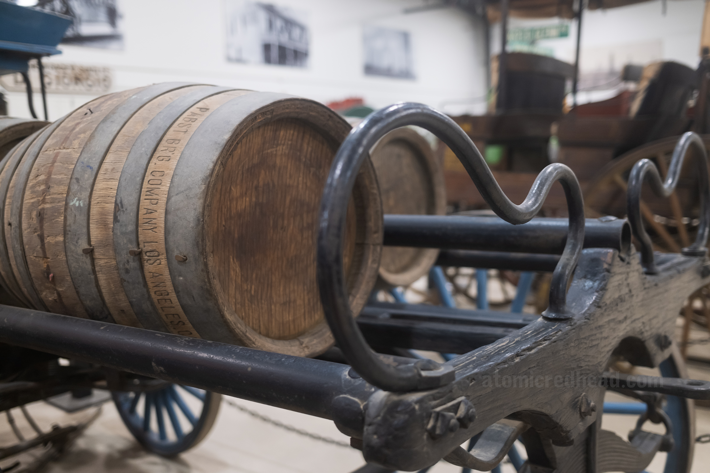 Close-up of beer barrels on an old beer cart.