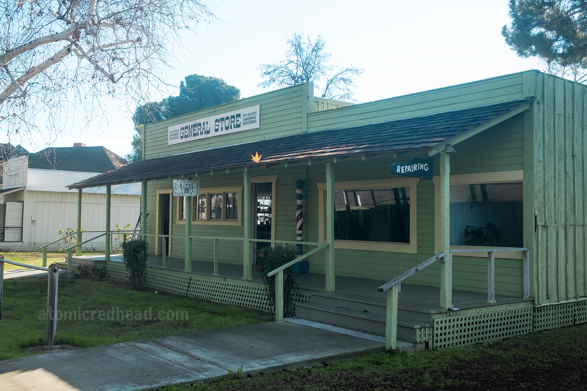A small general store painted green.