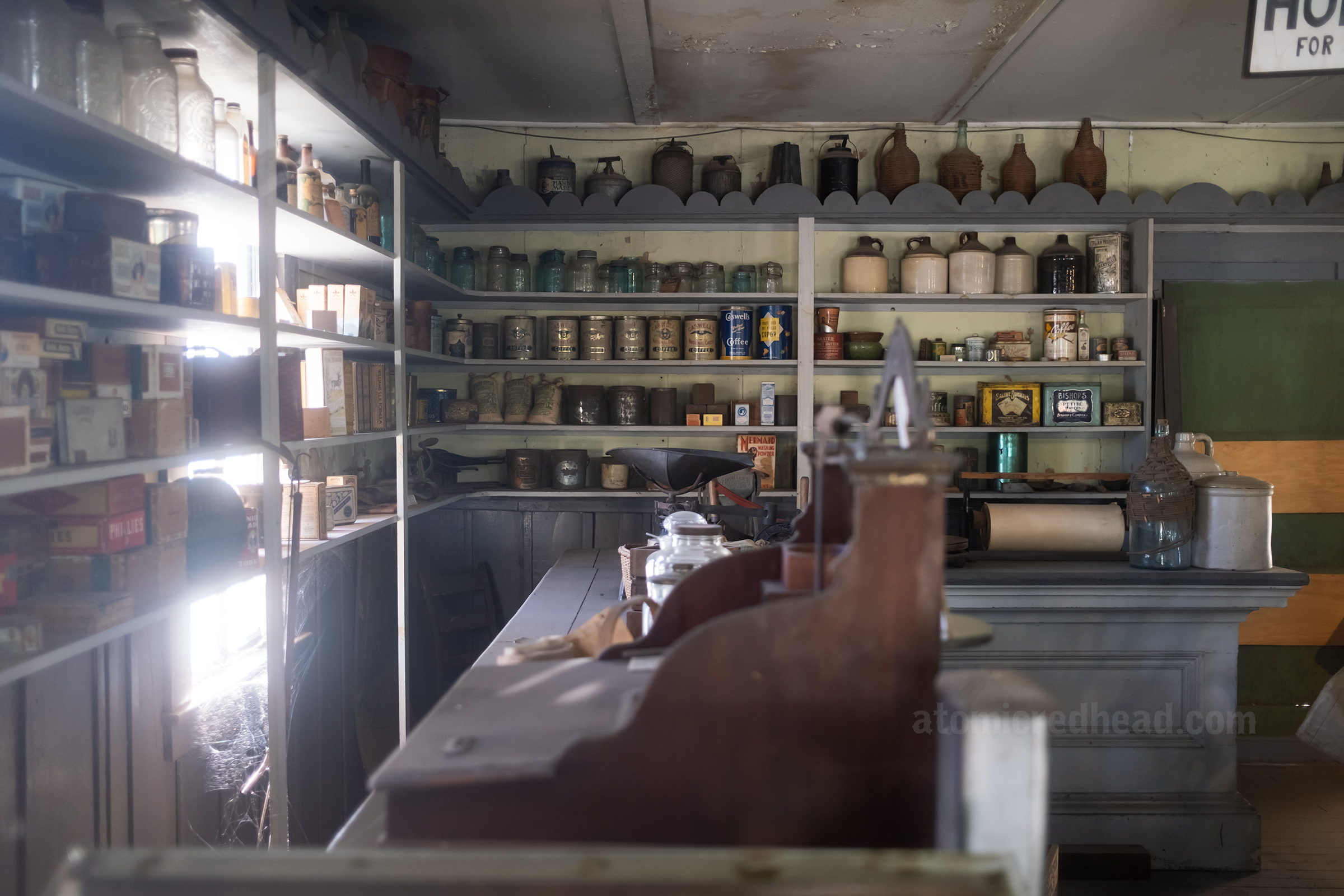Inside the general store with shelves of goods as they might appear in the 1800s.
