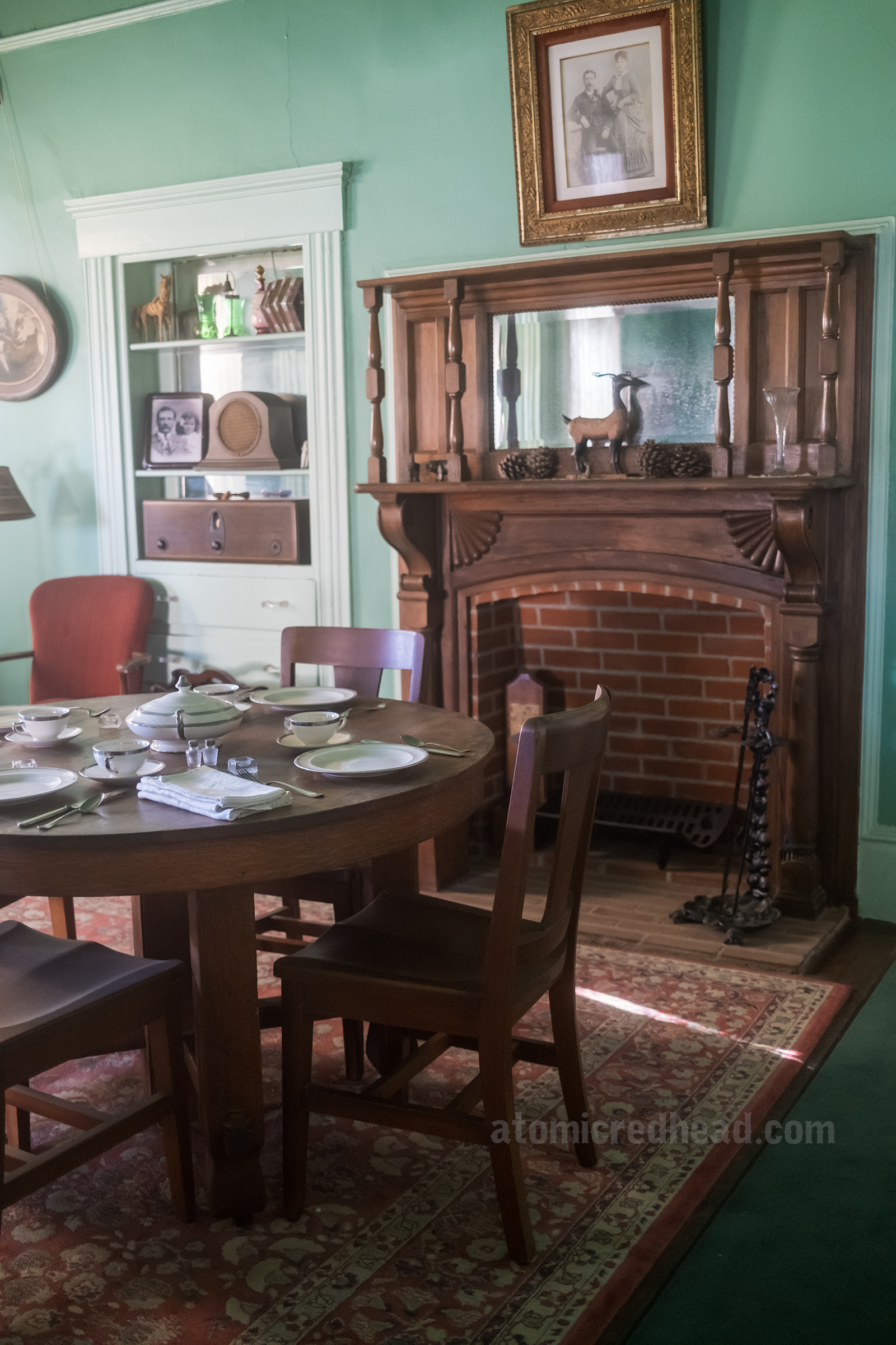 A Victorian dining room with fireplace inside the Lopez House.