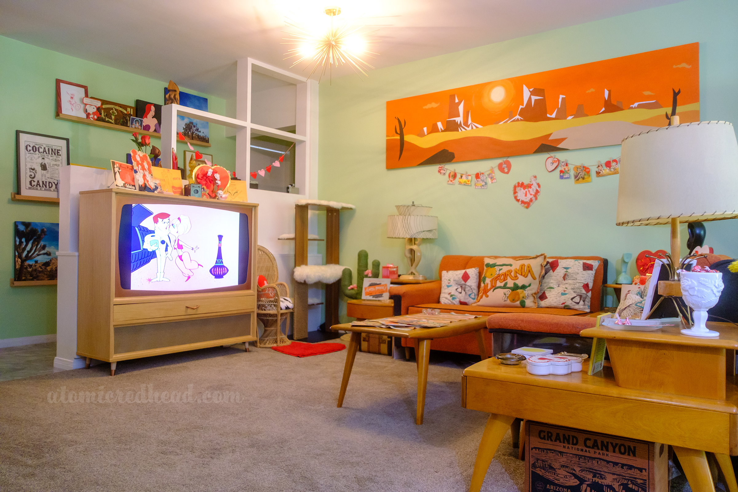 View of the TV with I Dream of Jeannie on the screen. Decorations sit on the top of the TV.