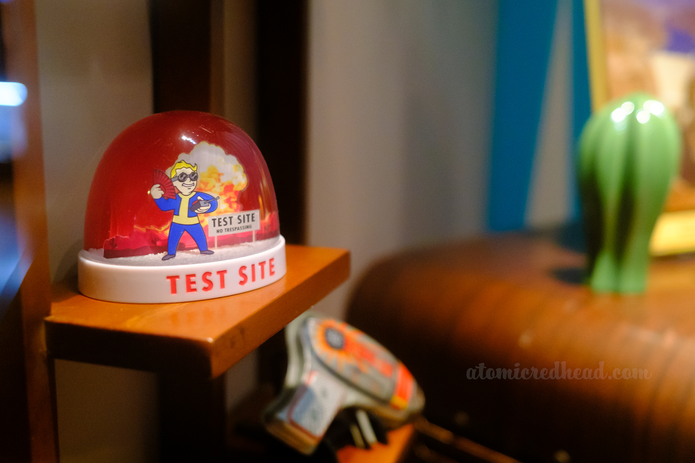 A snow globe features Vault Boy and a mushroom cloud in the background.