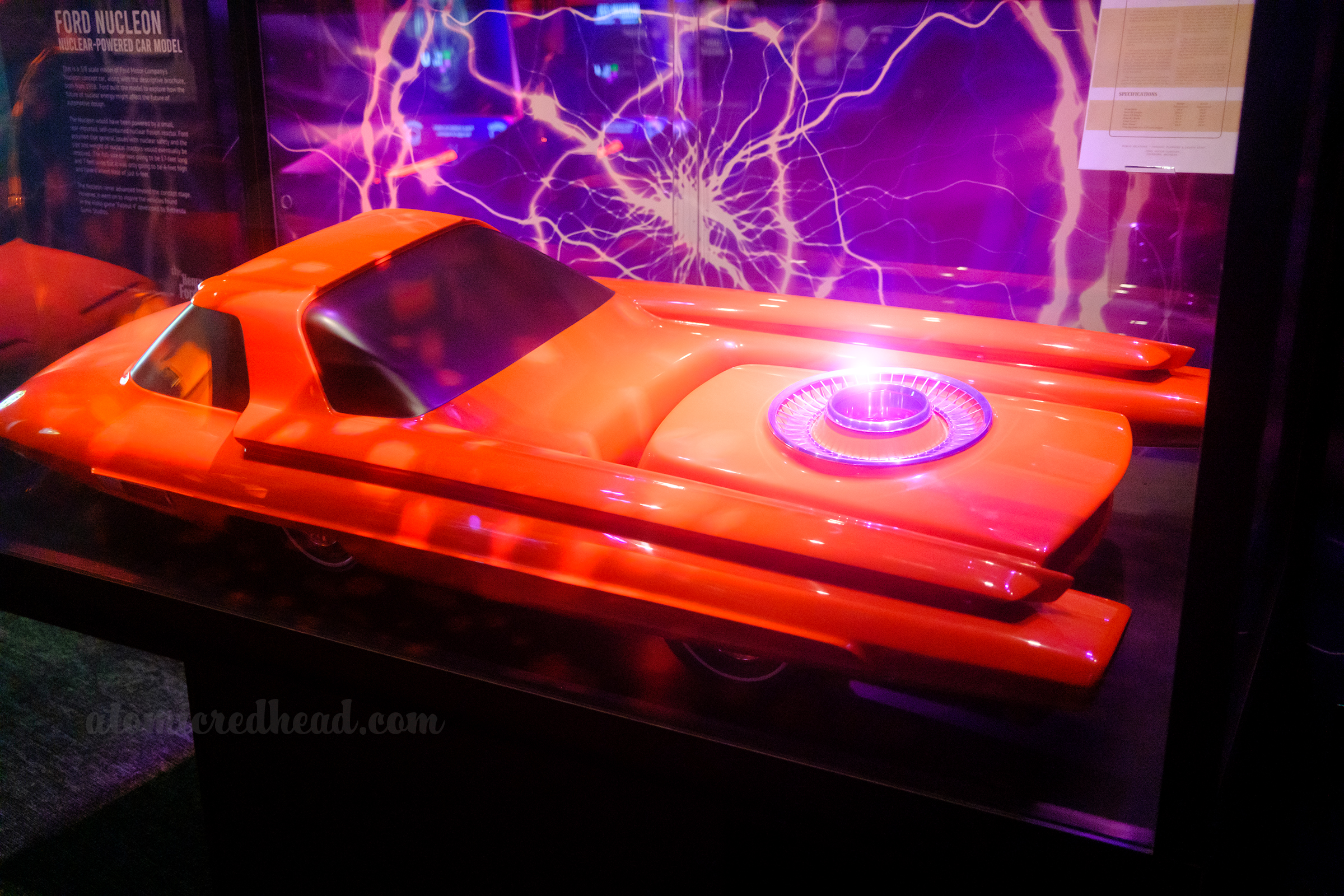 A vibrant orange model of the Ford Nucleon, a concept car run by atomic energy in 1958.