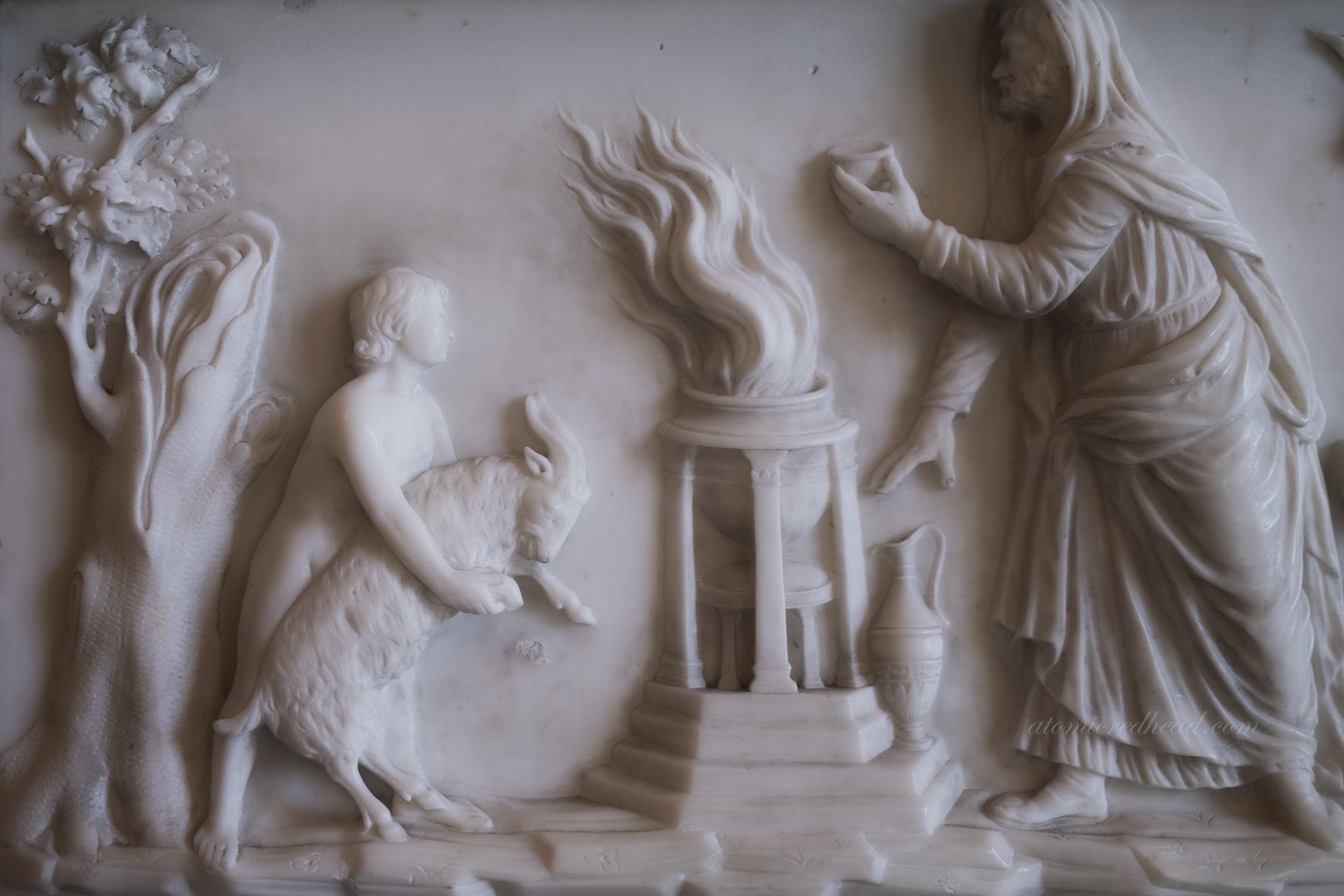 Close-up of the fireplace details, featuring a goat being held by a child