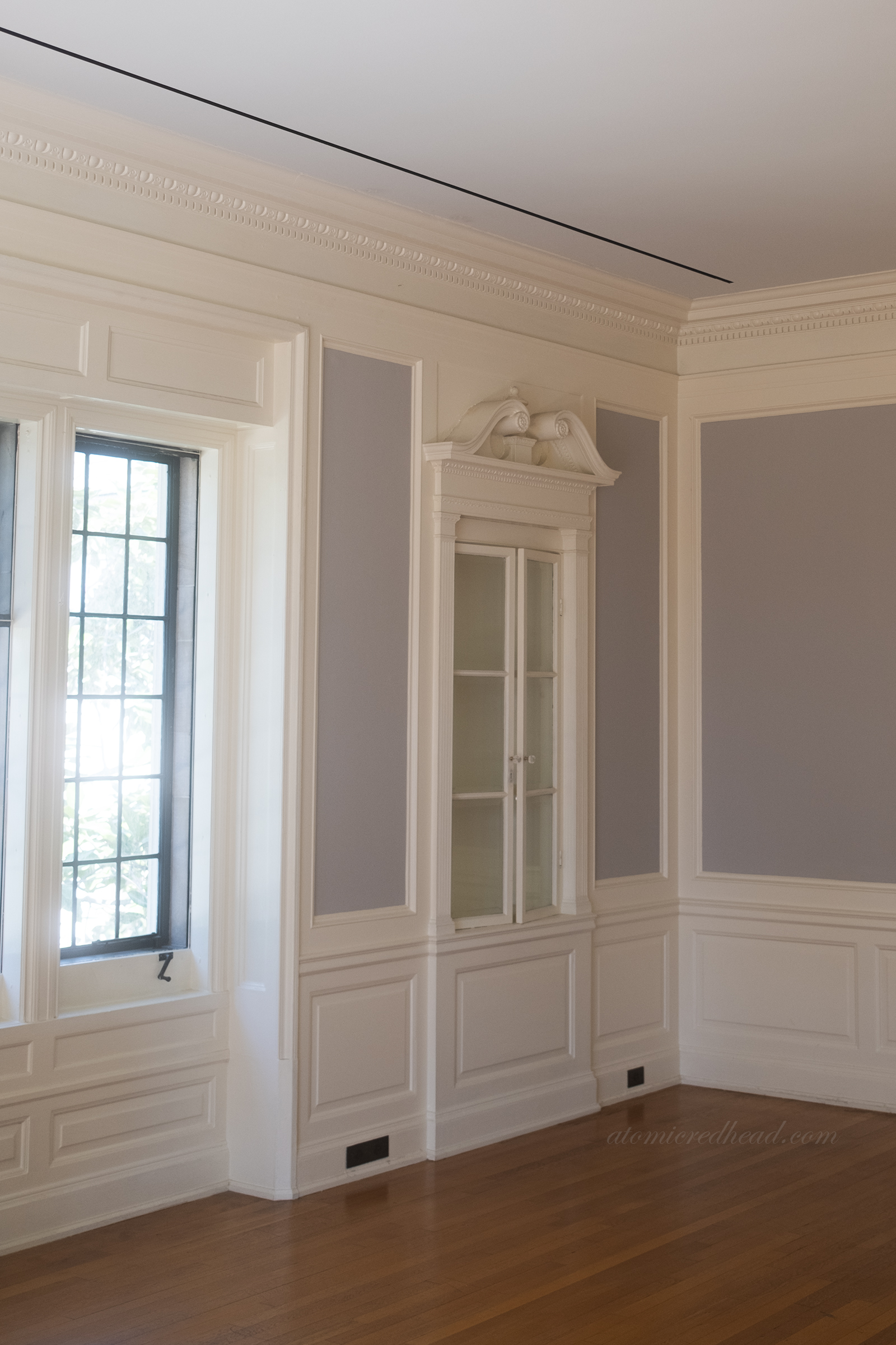 Built in cabinets in a pale grey and white room.