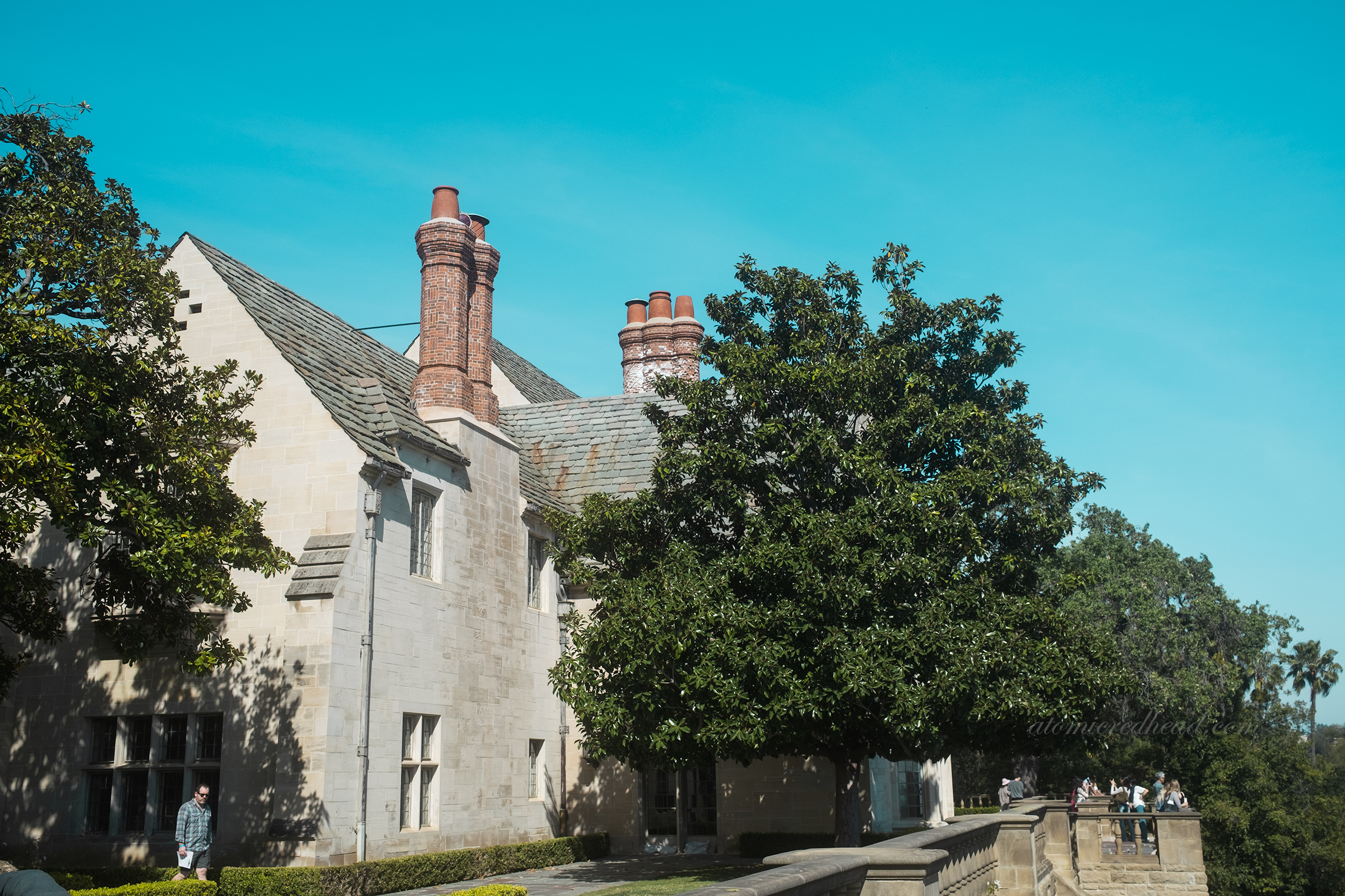 Brick chimneys rise from the slate roof.