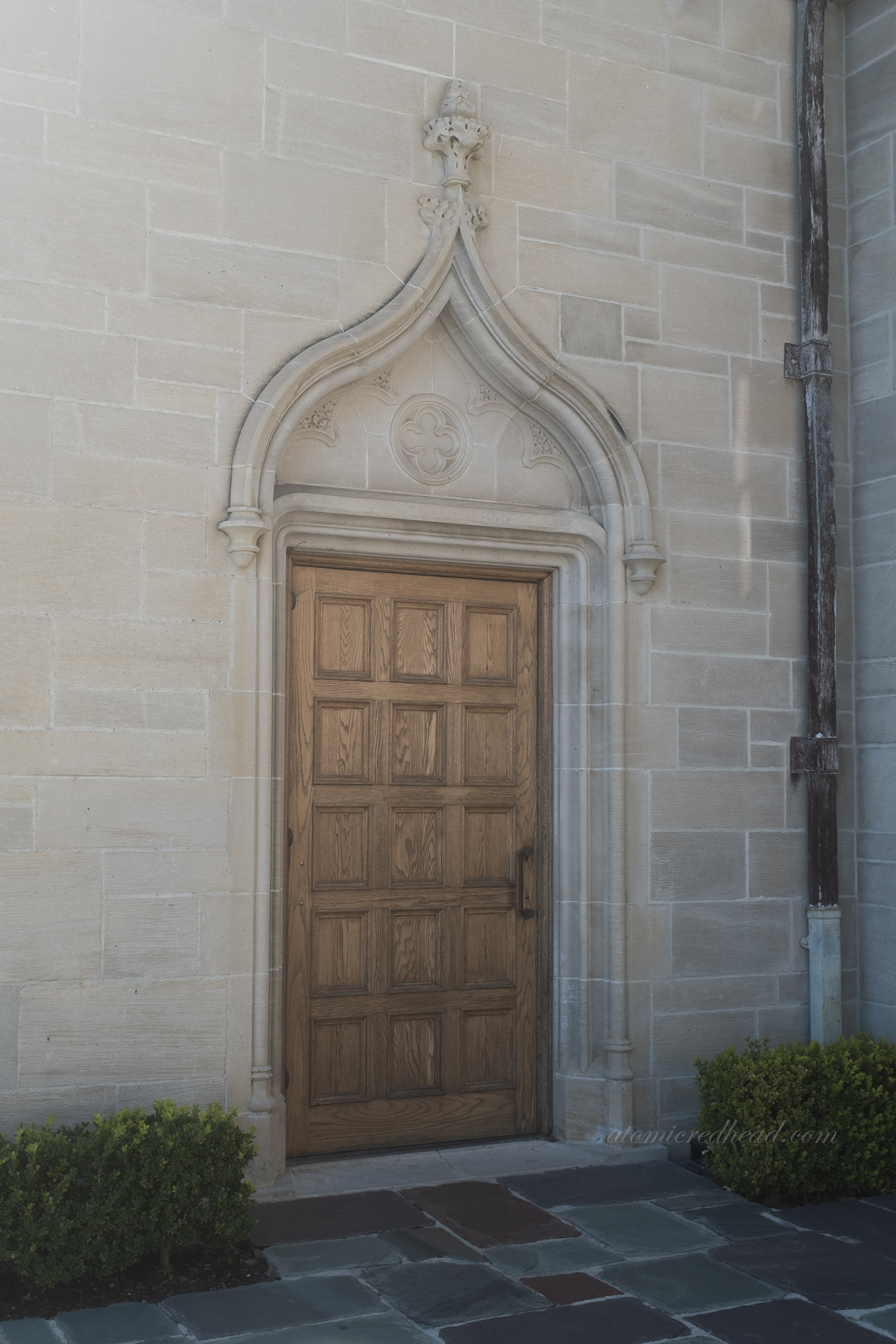 A large wooden door with a detailed archway above it.
