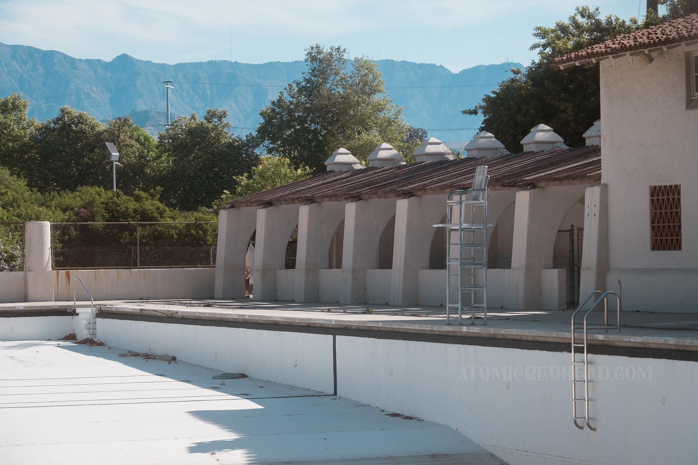 Close-up of the arched arcade area alongside the empty pool.