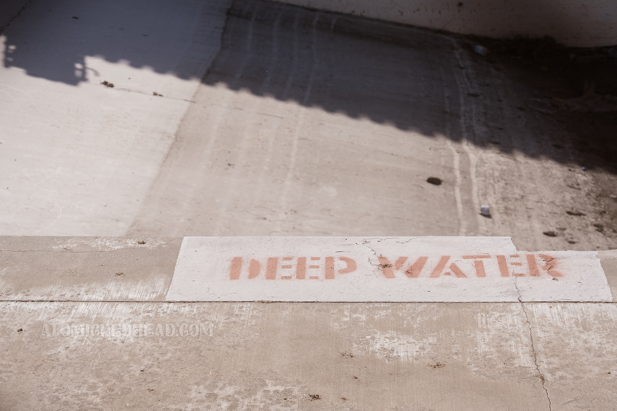 Close-up of red letters reading "DEEP WATER" and a portion of the edge is broken.