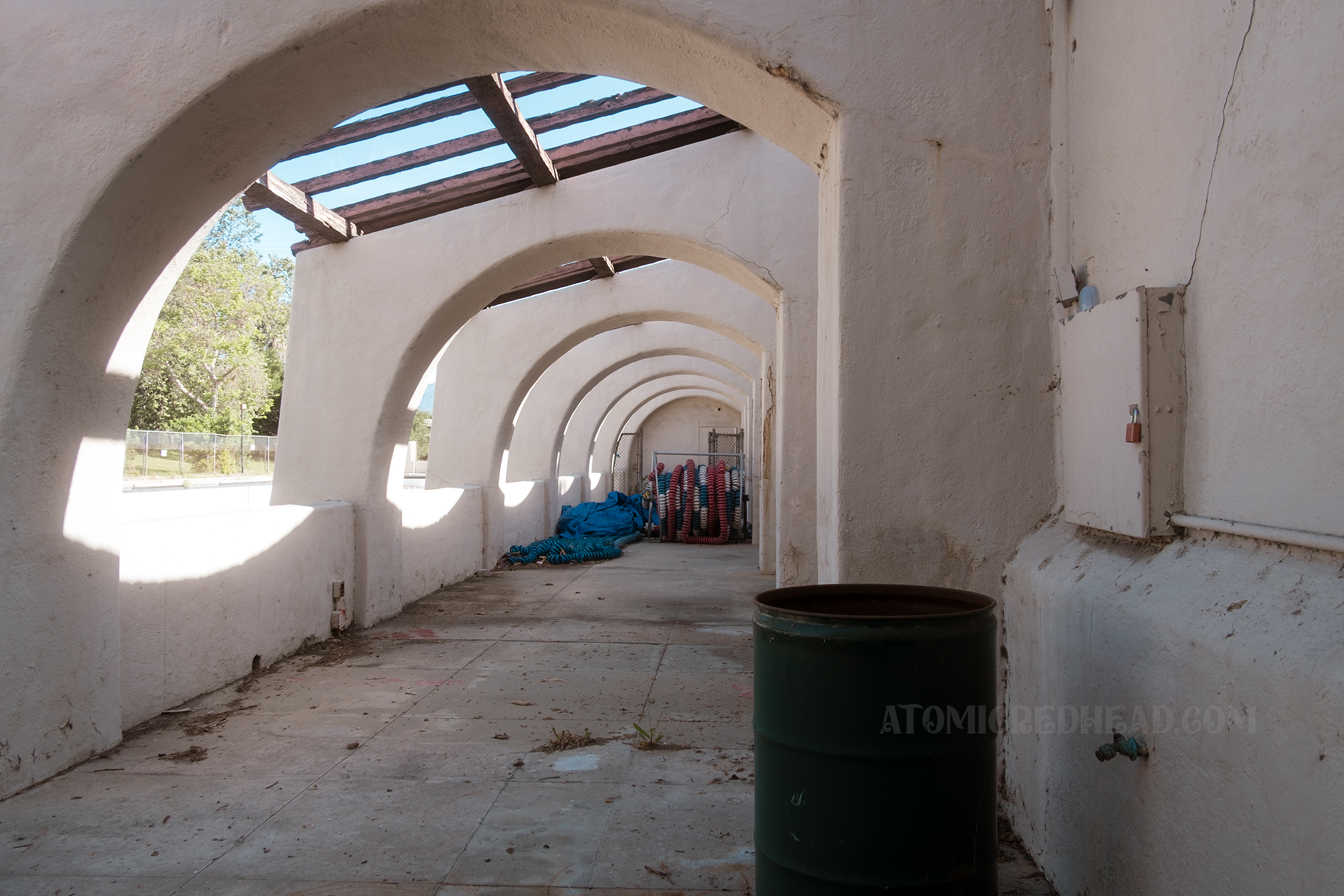 View down the arched arcade along side the pool.
