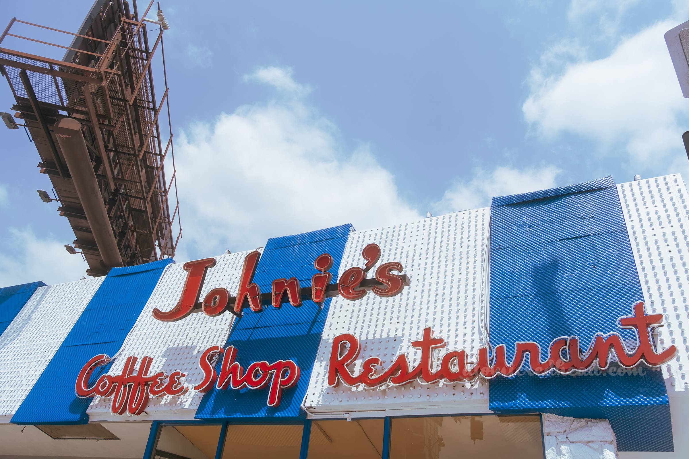 Close-up of the neon letters spelling out "Johnie's Coffee Shop Restaurant"