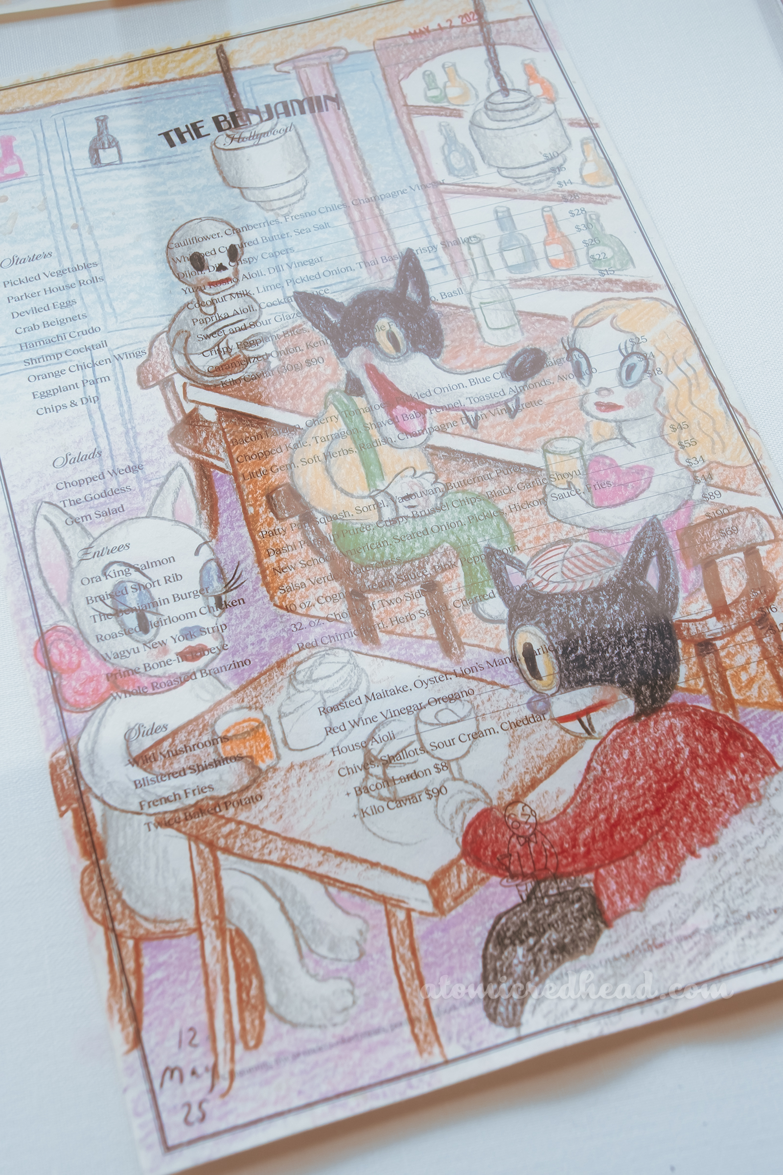One of Baseman's works, this one features a wolf at a bar next to a redhead, and a black cat dines with a white cat.