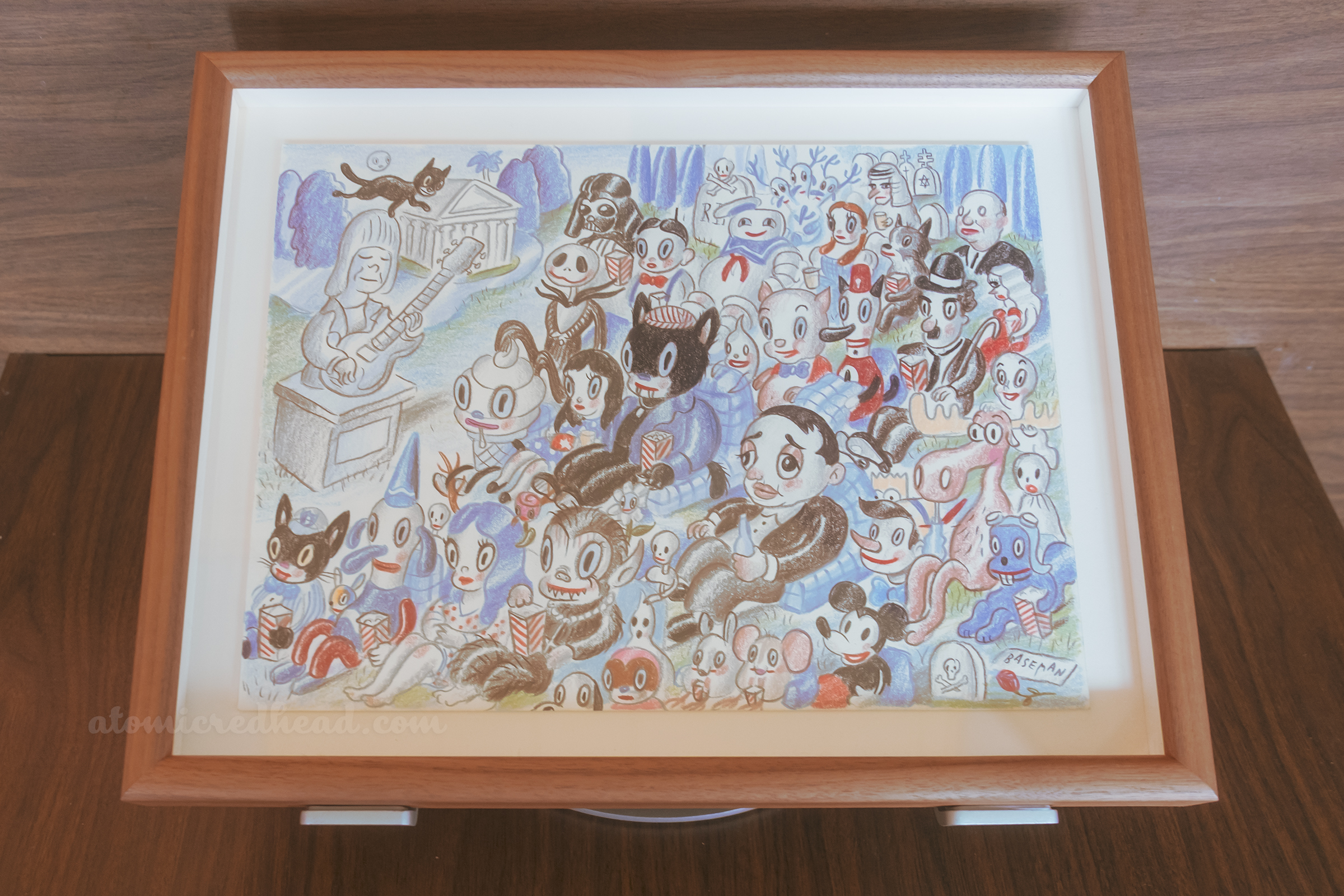 One of Baseman's works, this one features a group of colorful characters watching at movie at Hollywood Forever cemetery.