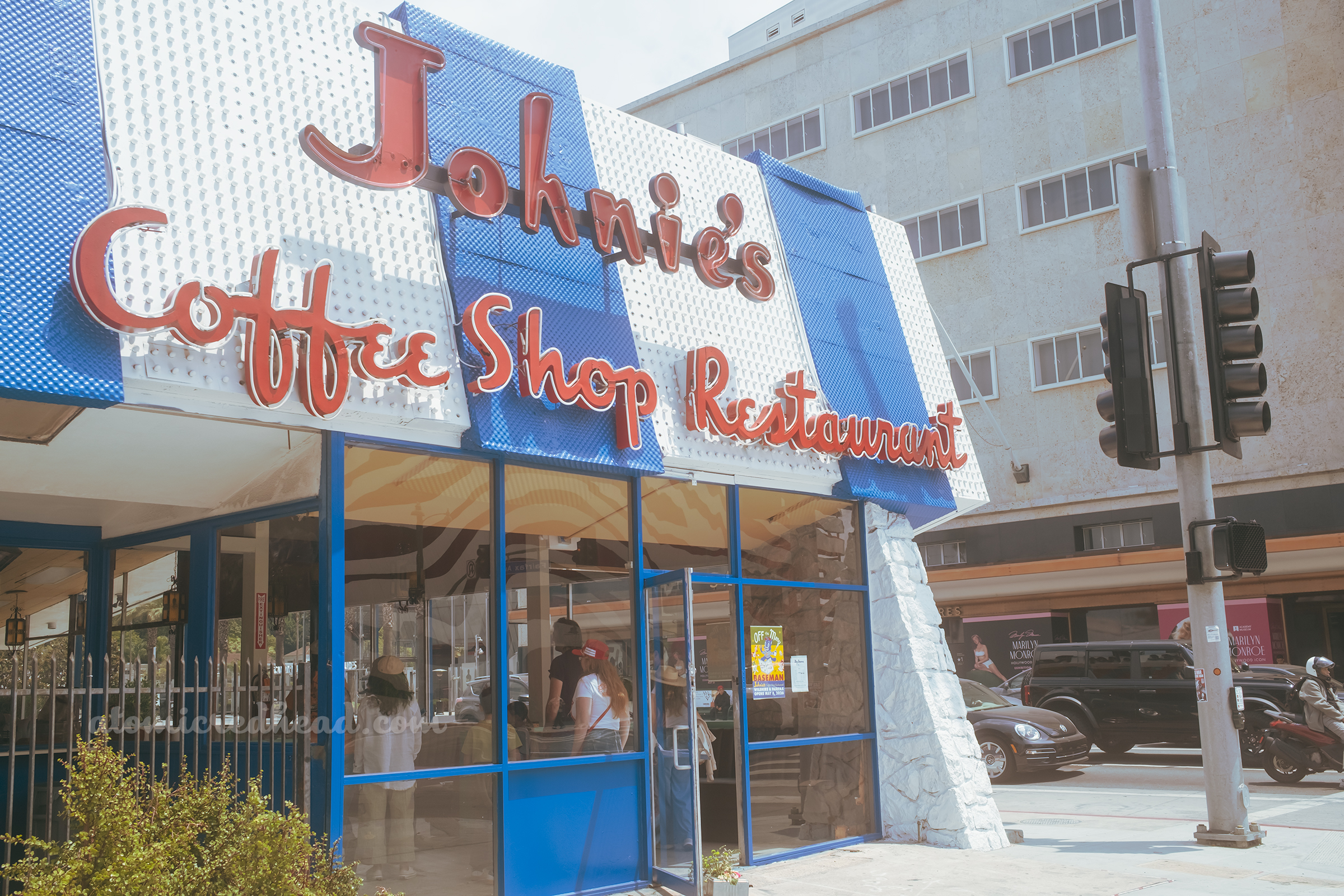 Close-up of the neon letters spelling out "Johnie's Coffee Shop Restaurant"