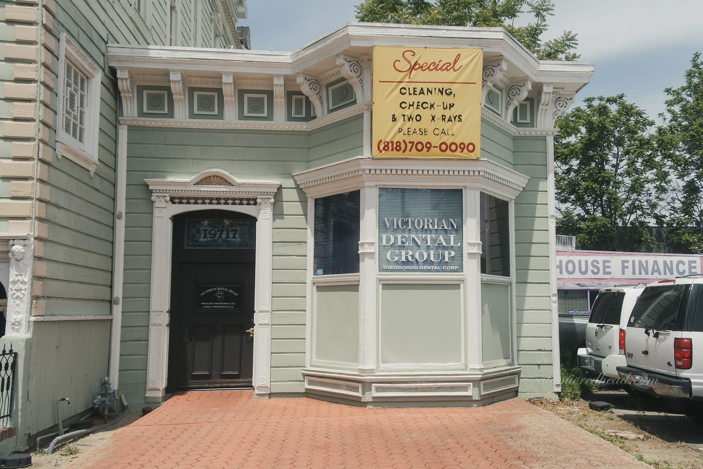 A single story, flat roof dentist office attached at the right side of the building.