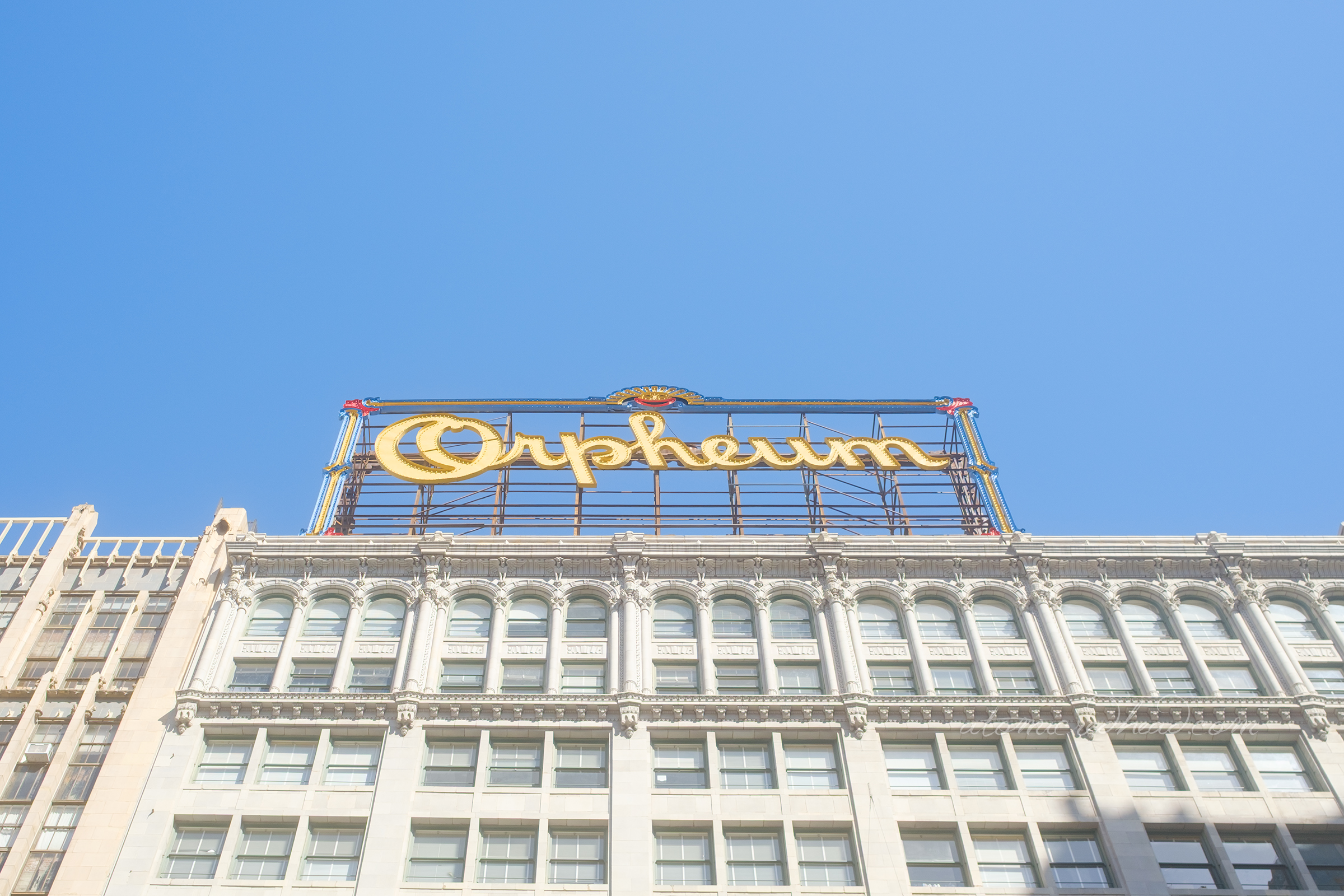 A massive multi-colored bulb sign reading "Orpheum" in yellow script.