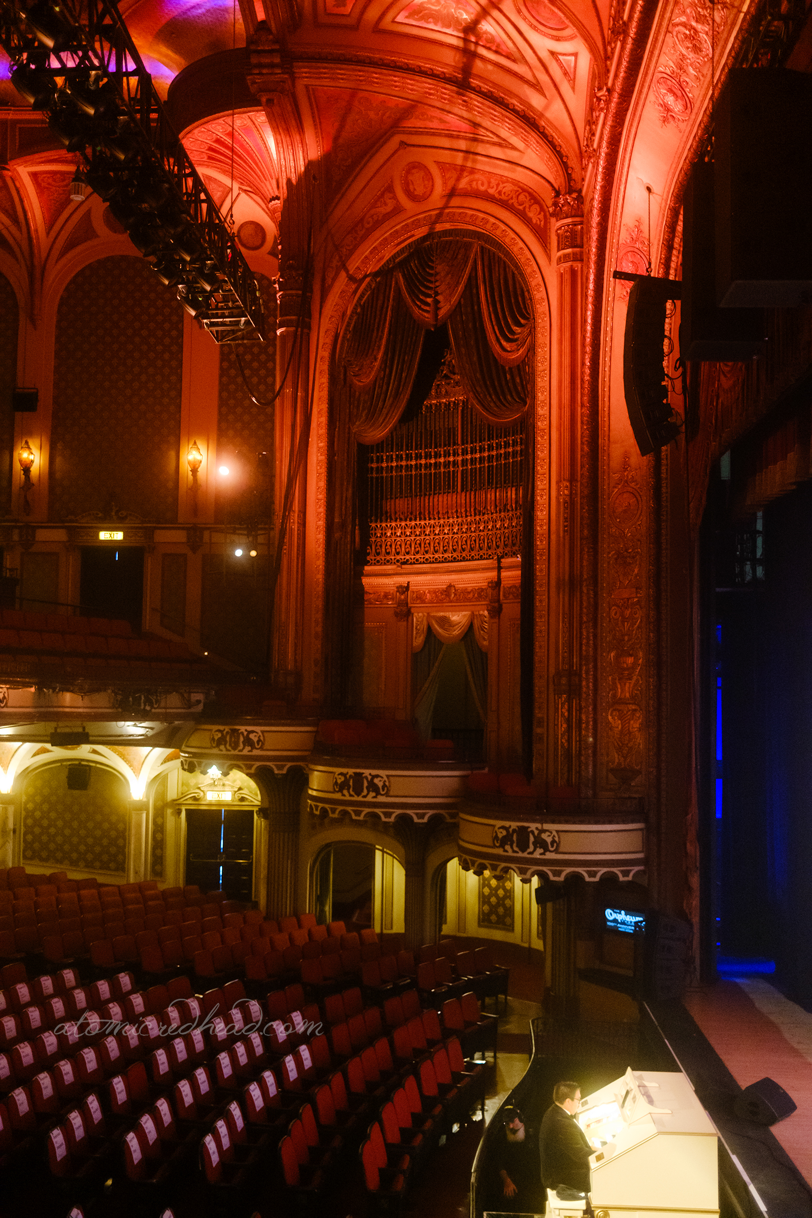 View of the box seats and the large arch that hides the organ pipes.