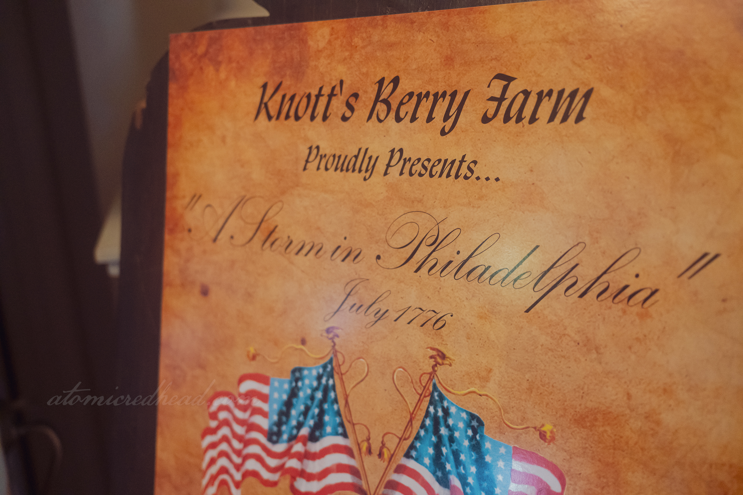 A sign reads "Knott's Berry Farm Proudly Presents...'A Storm in Philadelphia July 1776"