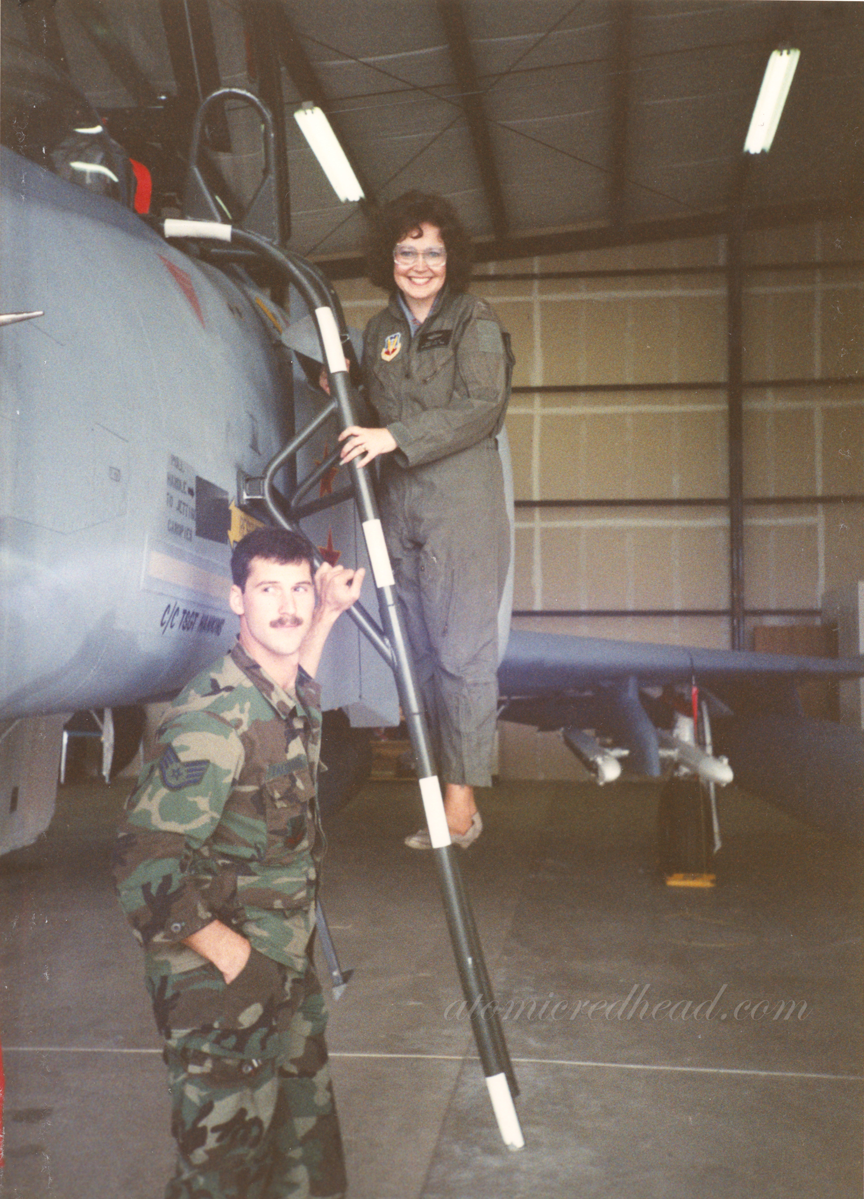 Photo of my mom in a flight suit near a plane.