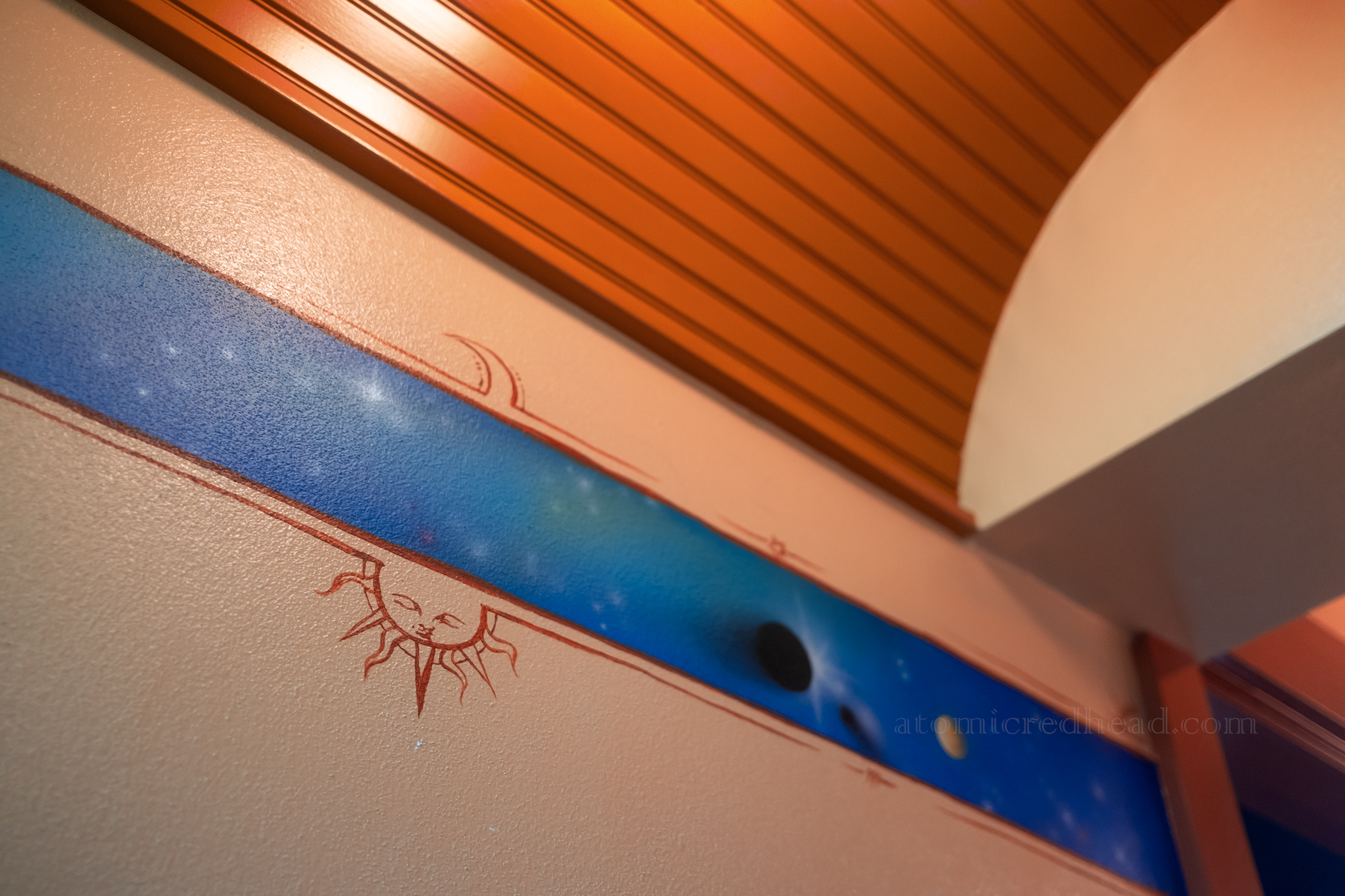 A celestial border on the wall of the bathroom.