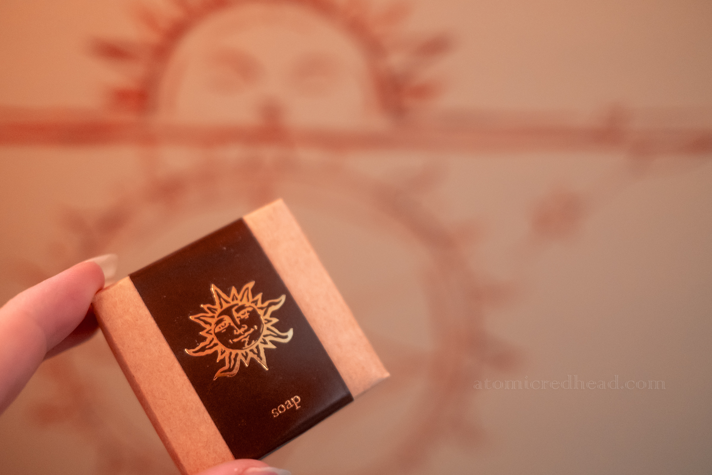 A box for soap that features a sun on it.